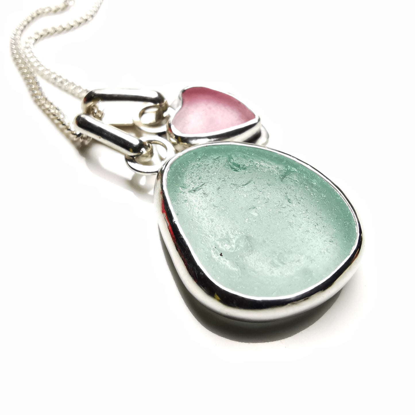 Tiny Scottish pink sea glass heart and light teal blue duo pendants in sterling silver.