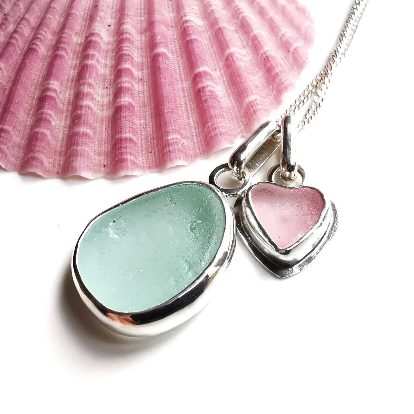 Tiny Scottish pink sea glass heart and light teal blue duo pendants in sterling silver.