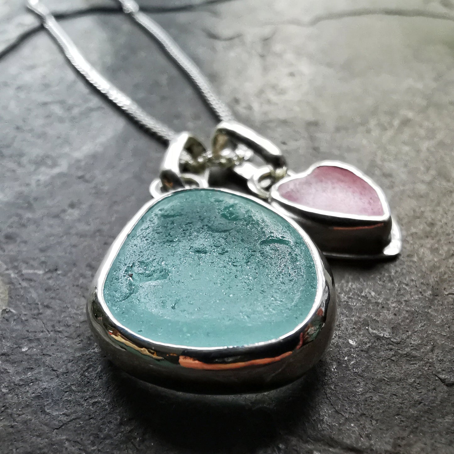 Tiny Scottish pink sea glass heart and light teal blue duo pendants in sterling silver.