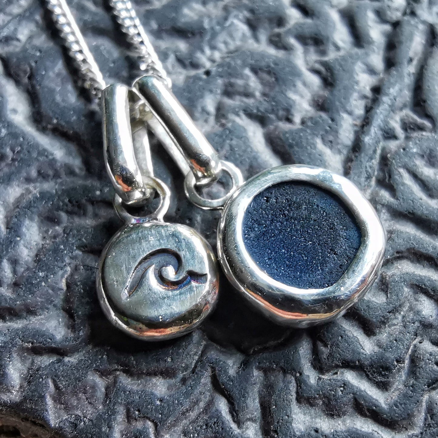 Tiny Scottish teal blue sea glass and wave pebble duo of sterling silver pendants.