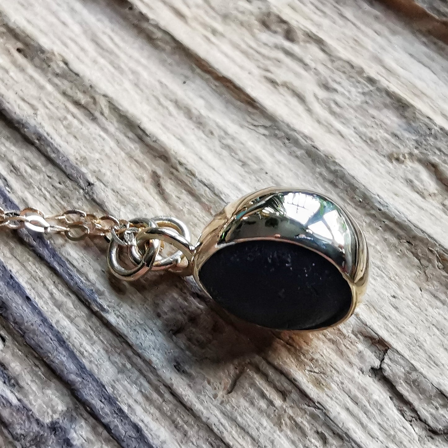 Genuine black sea glass & 9ct gold pendant.