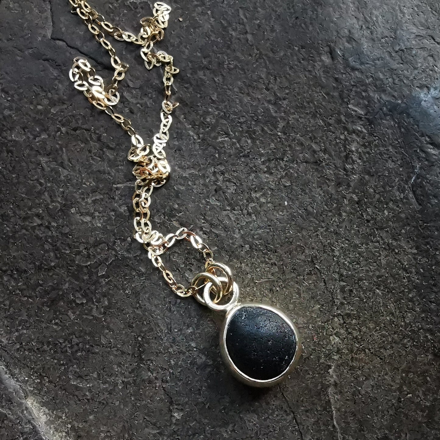 Genuine black sea glass & 9ct gold pendant.