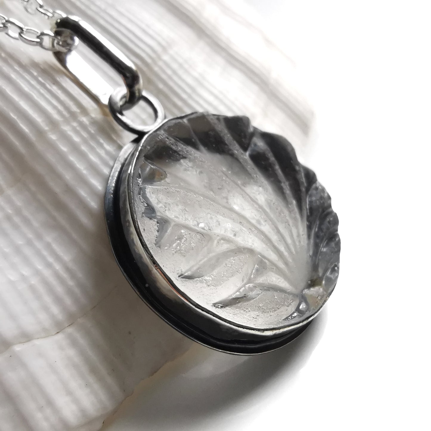 Clear sea glass & sterling silver pendant.