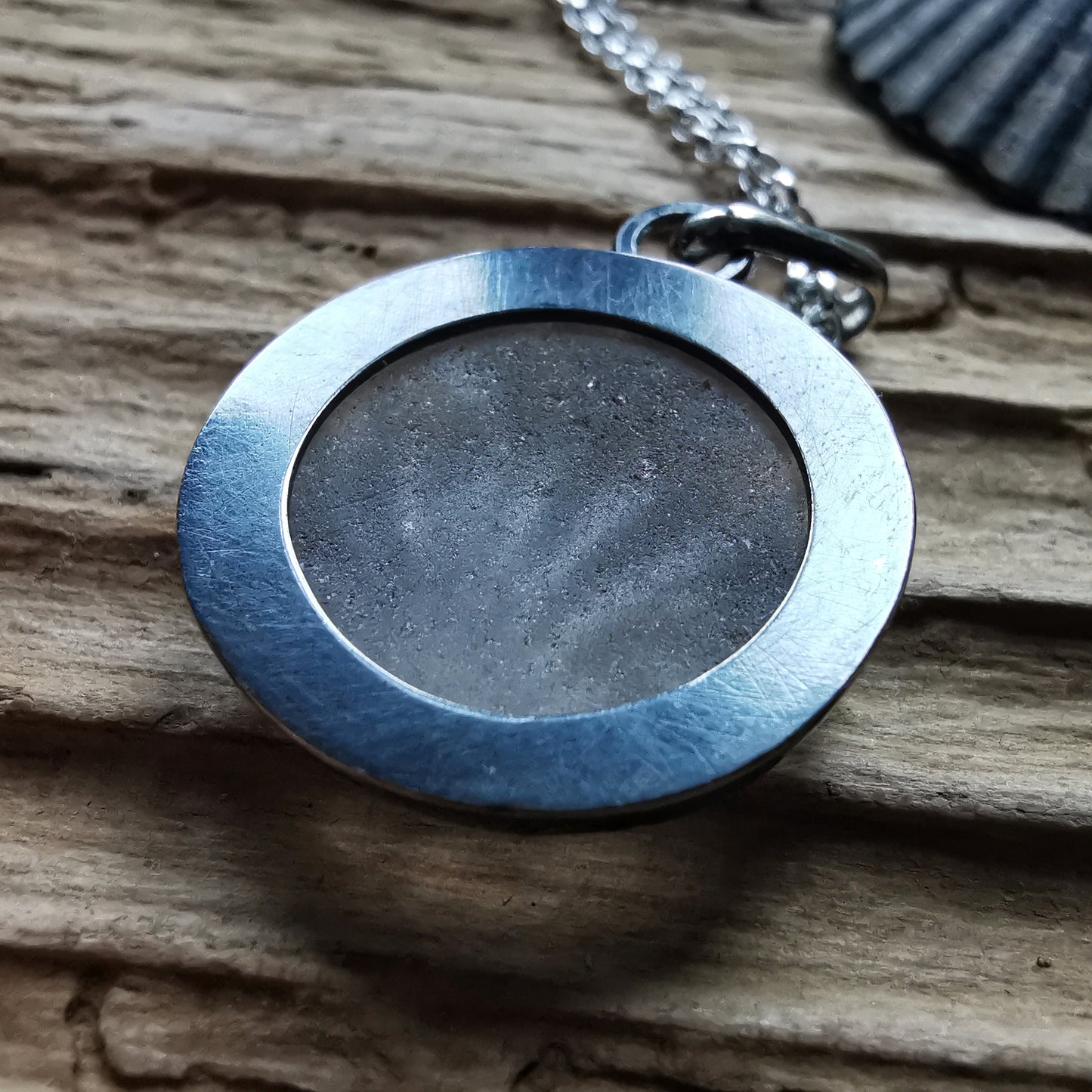 Clear sea glass & sterling silver pendant.