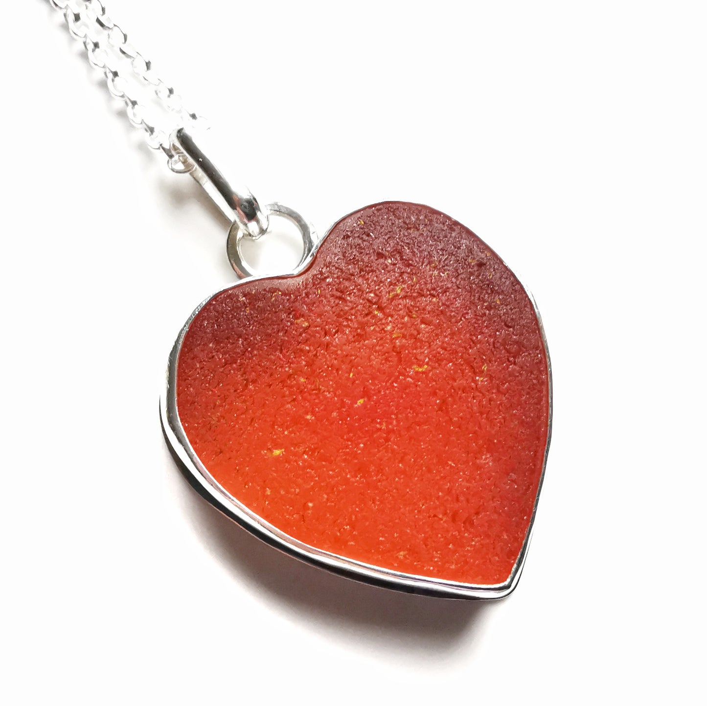 Reserved. Scottish UV deep orange sea glass heart & sterling silver pendant.