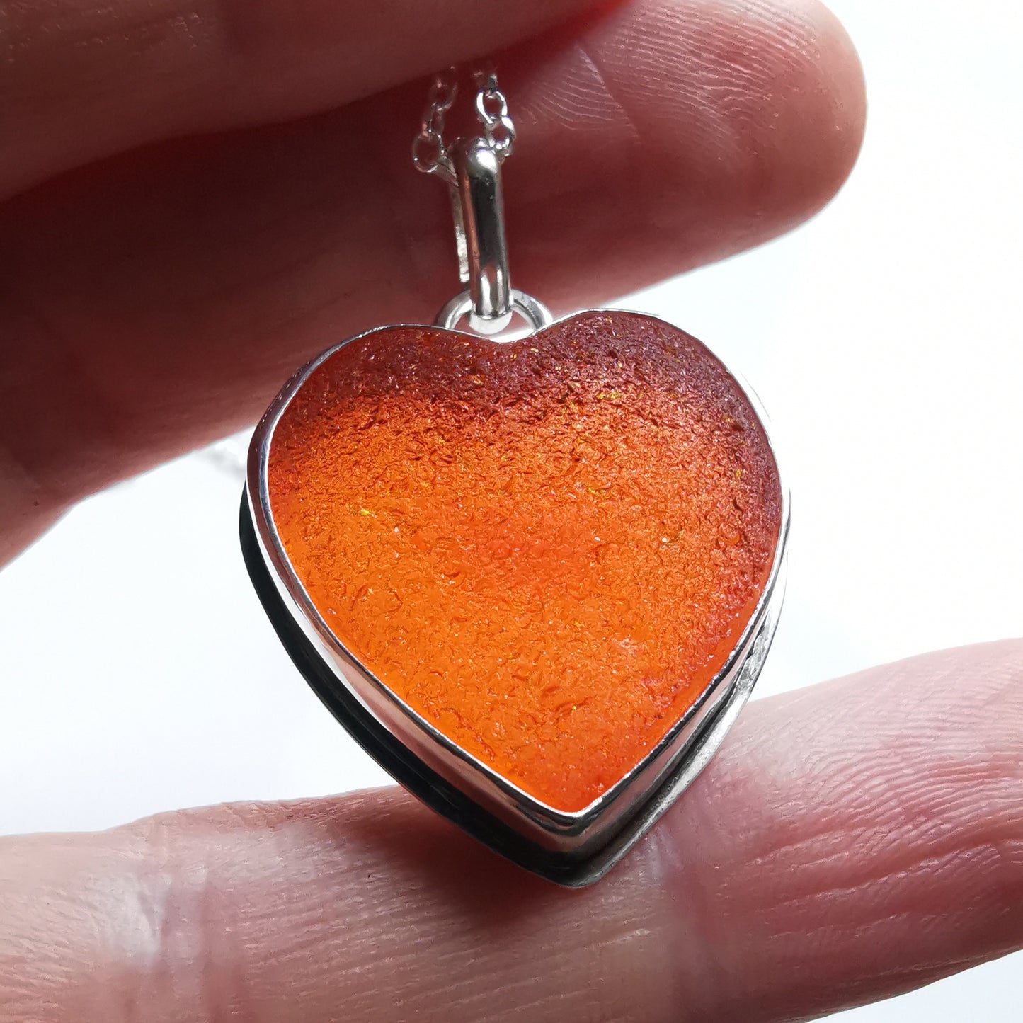 Reserved. Scottish UV deep orange sea glass heart & sterling silver pendant.