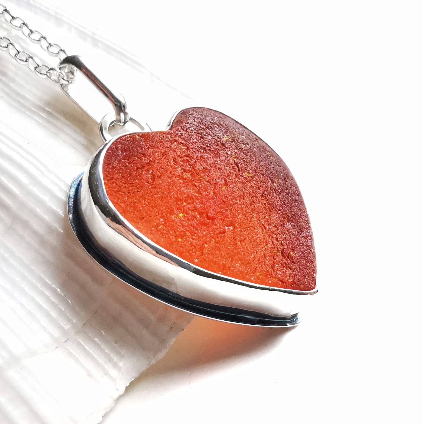 Reserved. Scottish UV deep orange sea glass heart & sterling silver pendant.