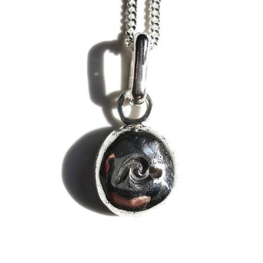 Sterling silver wave pebble pendant.