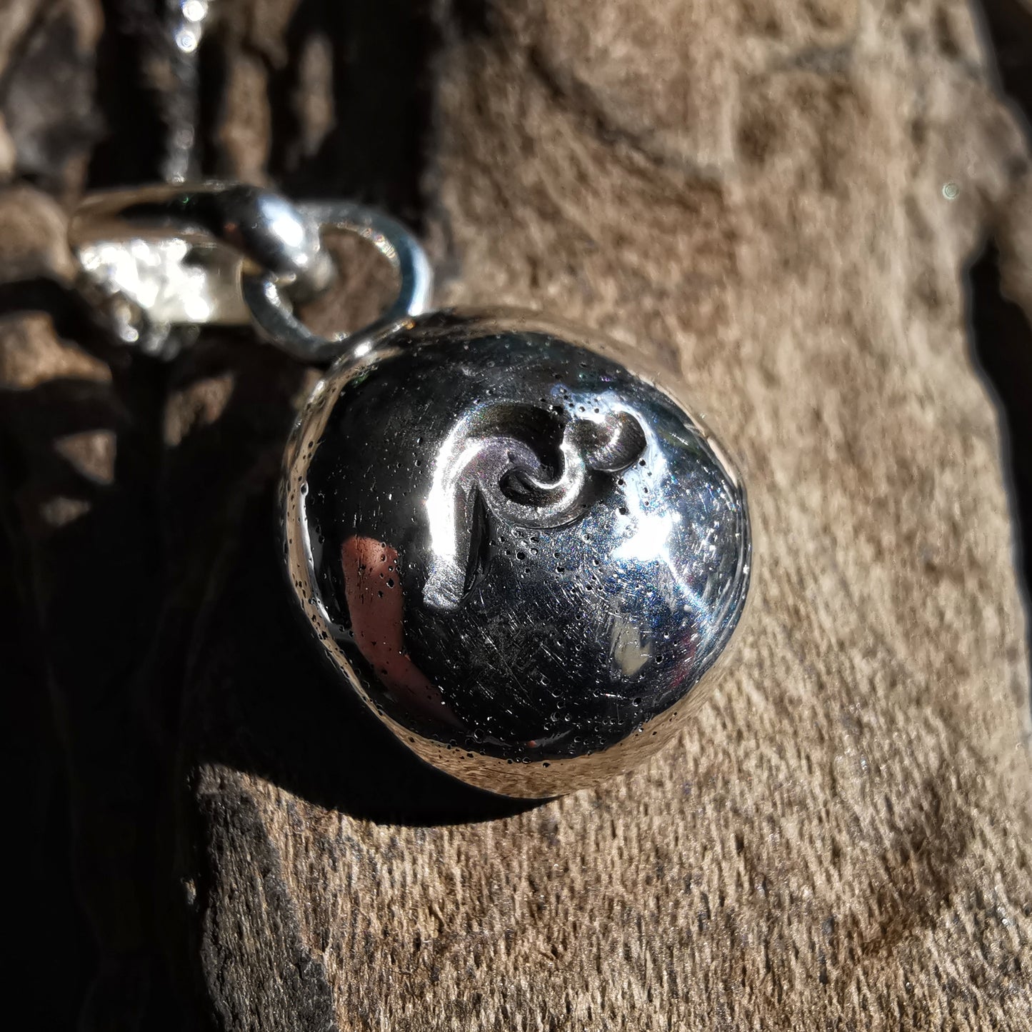 Sterling silver wave pebble pendant.
