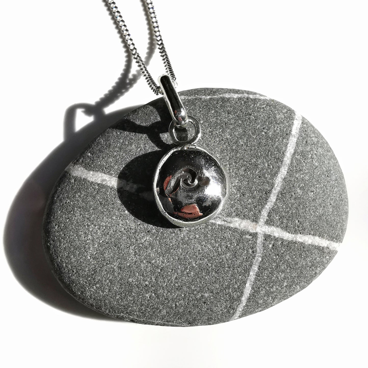 Sterling silver wave pebble pendant.