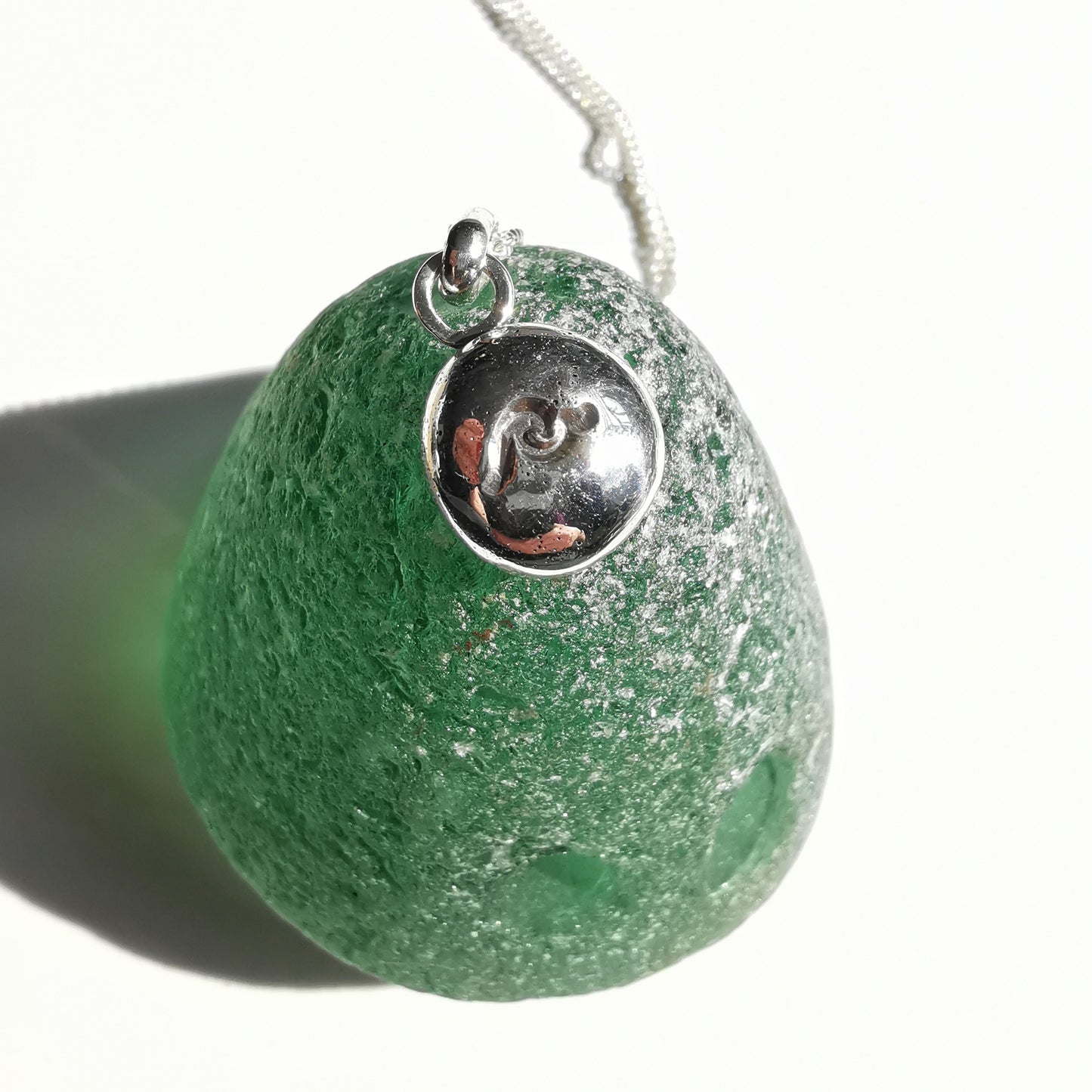 Sterling silver wave pebble pendant.
