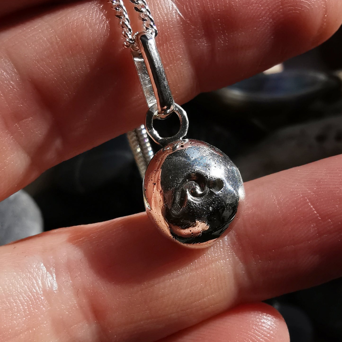 Sterling silver wave pebble pendant.