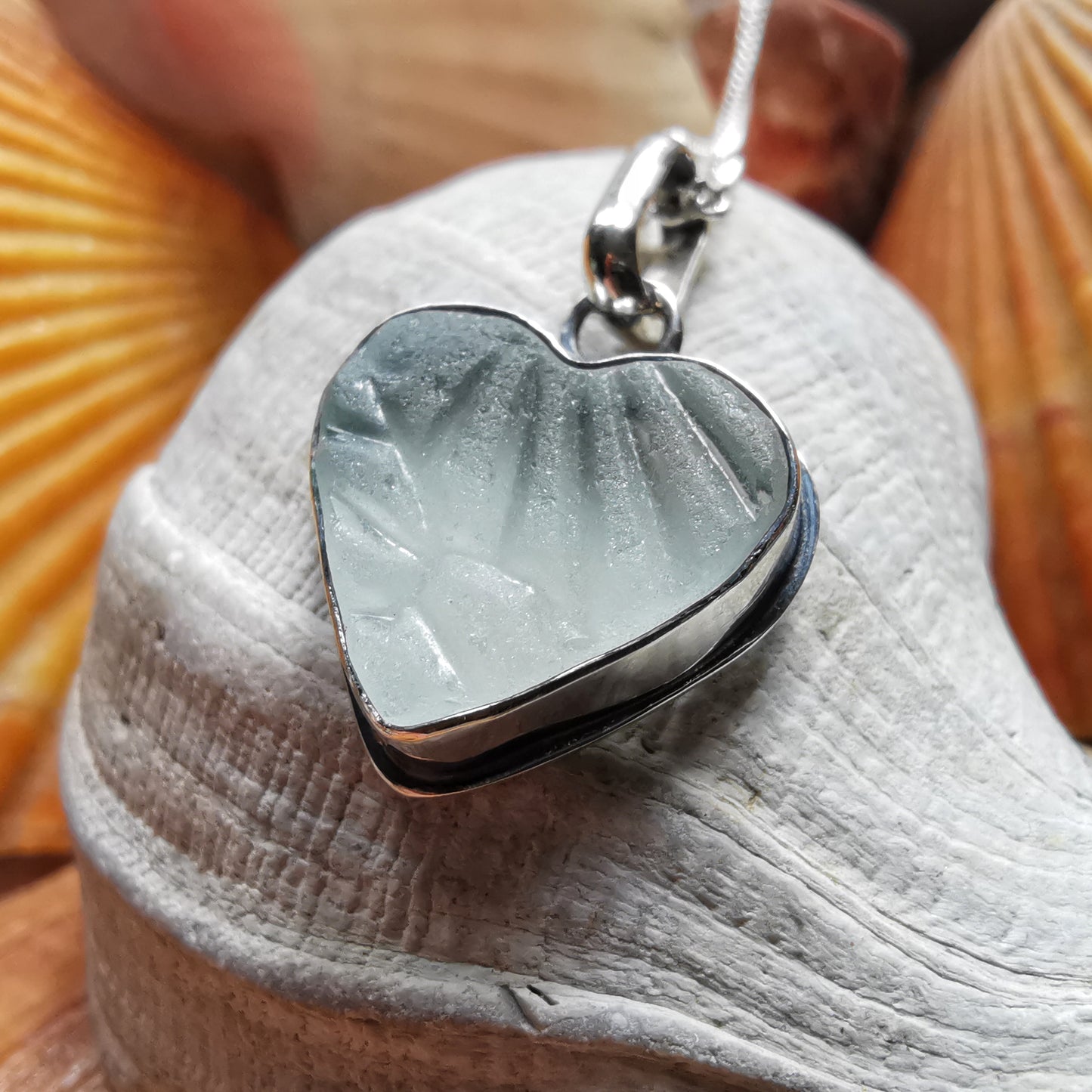 Clear sea glass heart & sterling silver pendant.