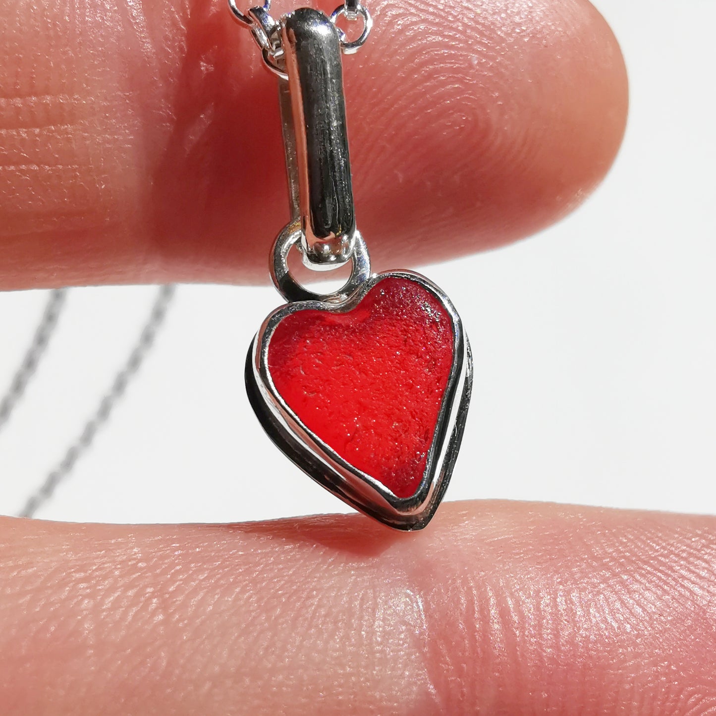 Tiny Scottish UV red sea glass heart & sterling silver pendant.