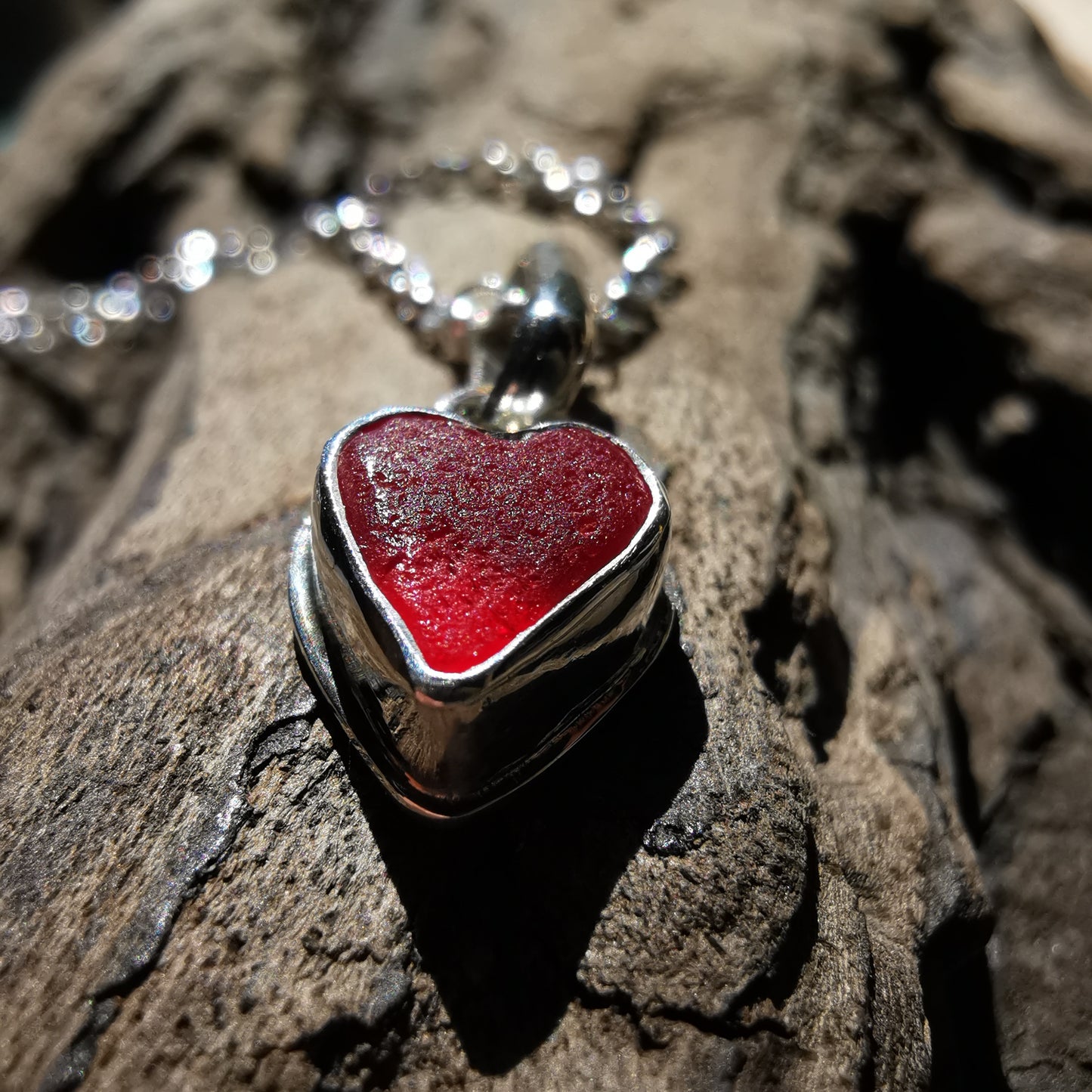 Tiny Scottish UV red sea glass heart & sterling silver pendant.