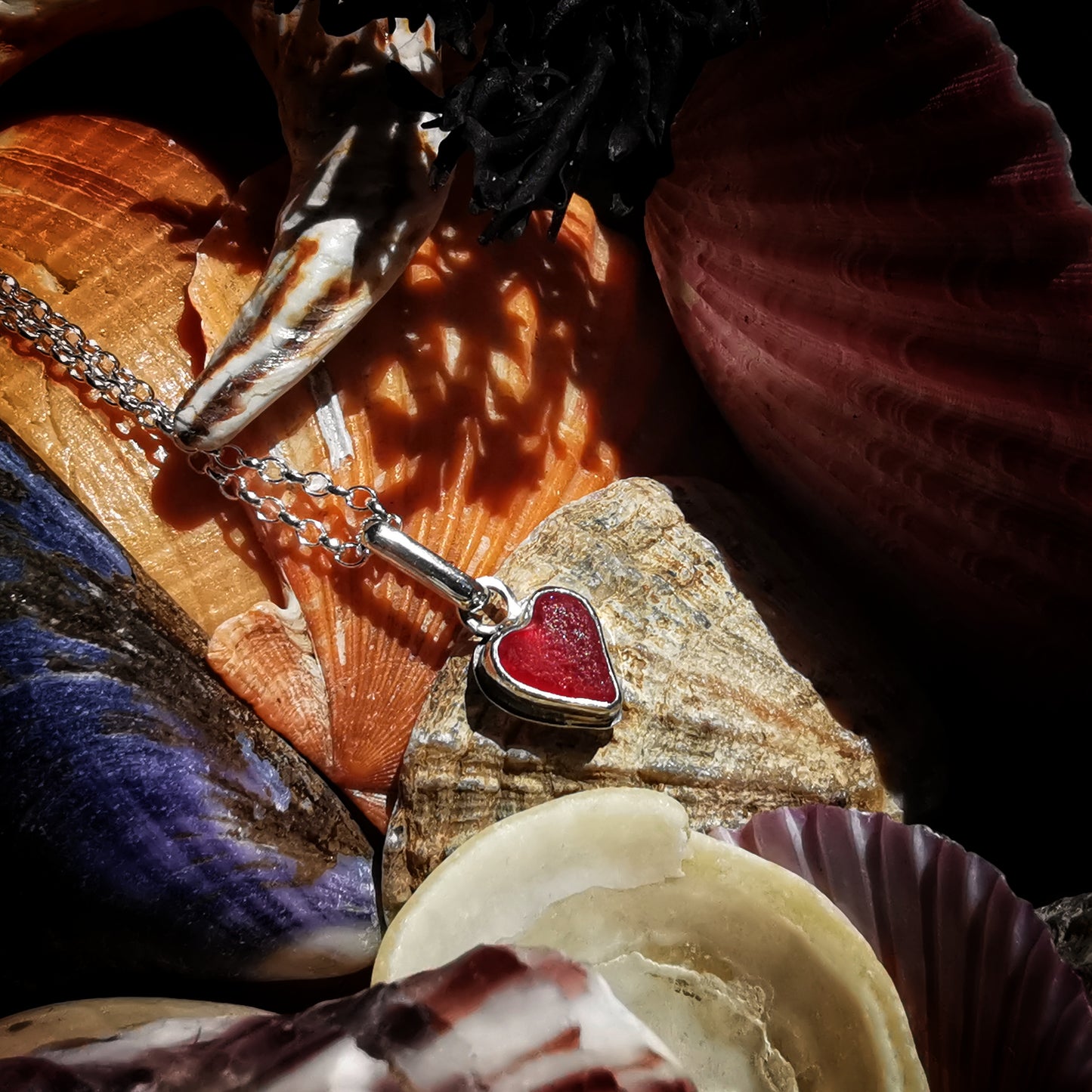 Tiny Scottish UV red sea glass heart & sterling silver pendant.