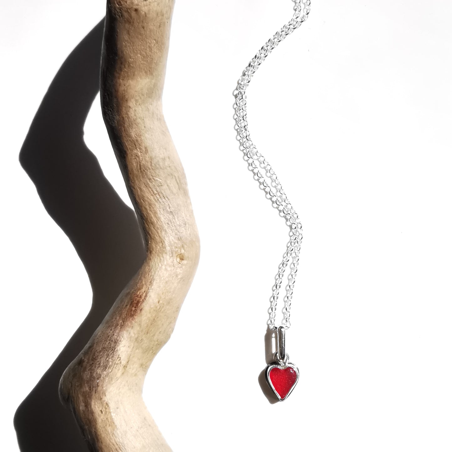 Tiny Scottish UV red sea glass heart & sterling silver pendant.