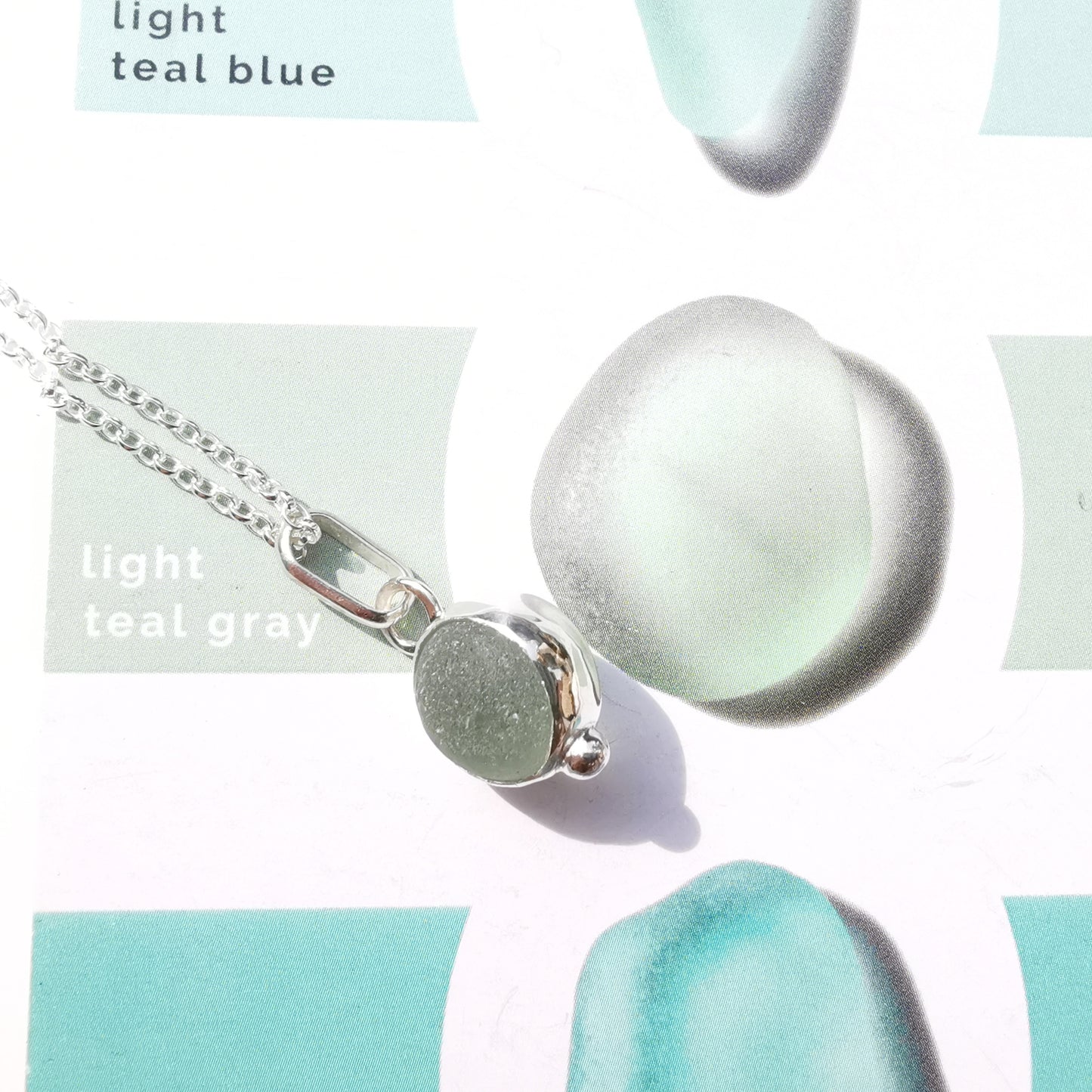 Genuine tiny Scottish Codd sea glass marble & sterling silver pendant.