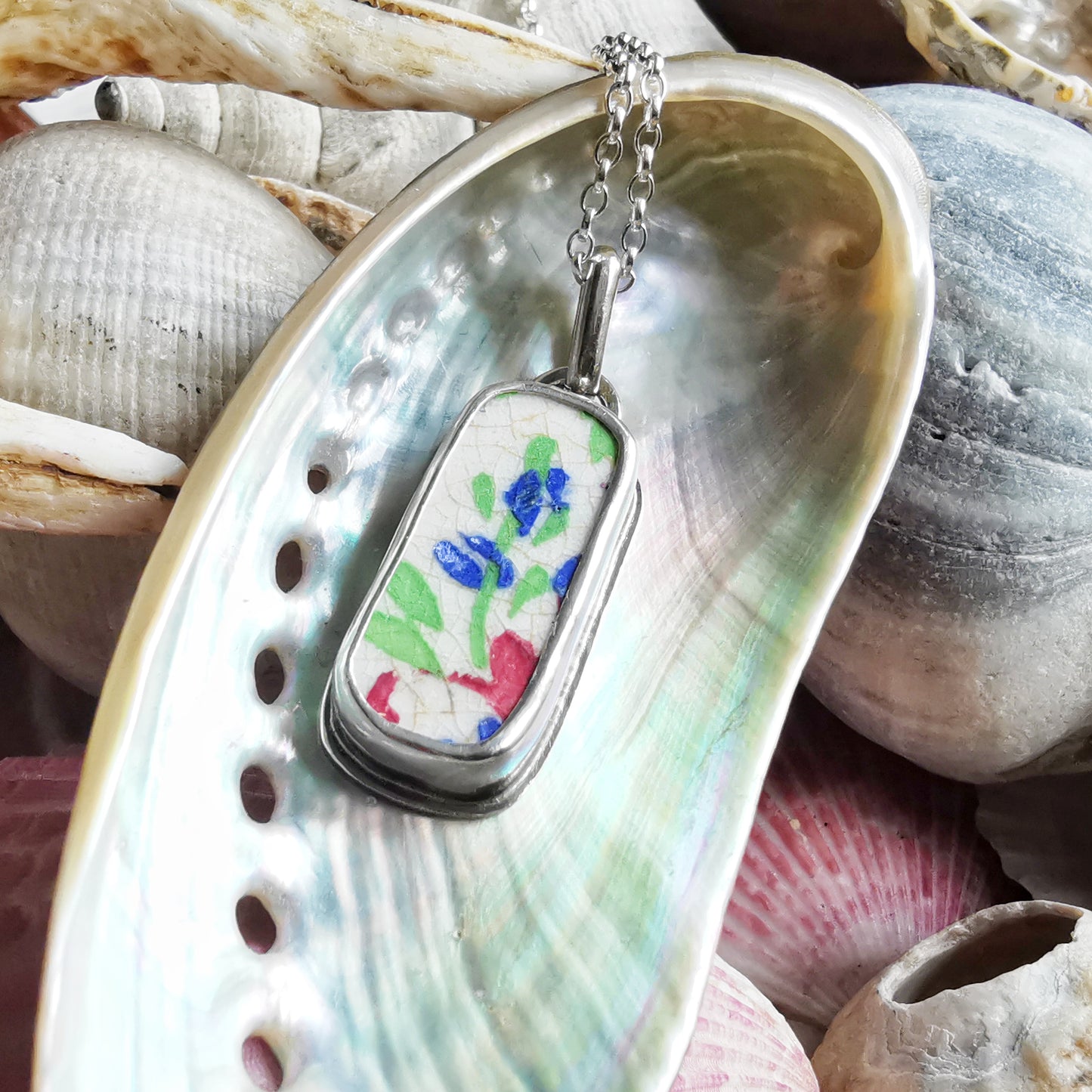 Scottish foliage pattern sea pottery & sterling silver pendant.