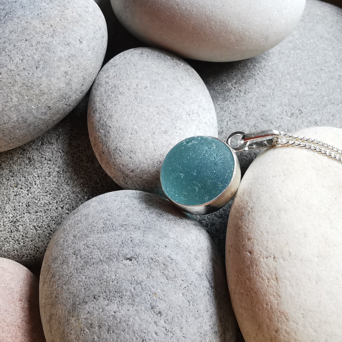 Light blue sea glass marble & sterling silver pendant.
