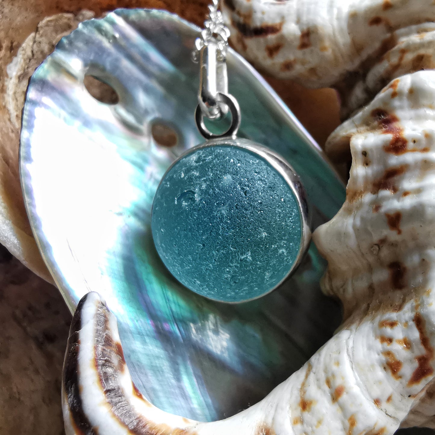 Light blue sea glass marble & sterling silver pendant.