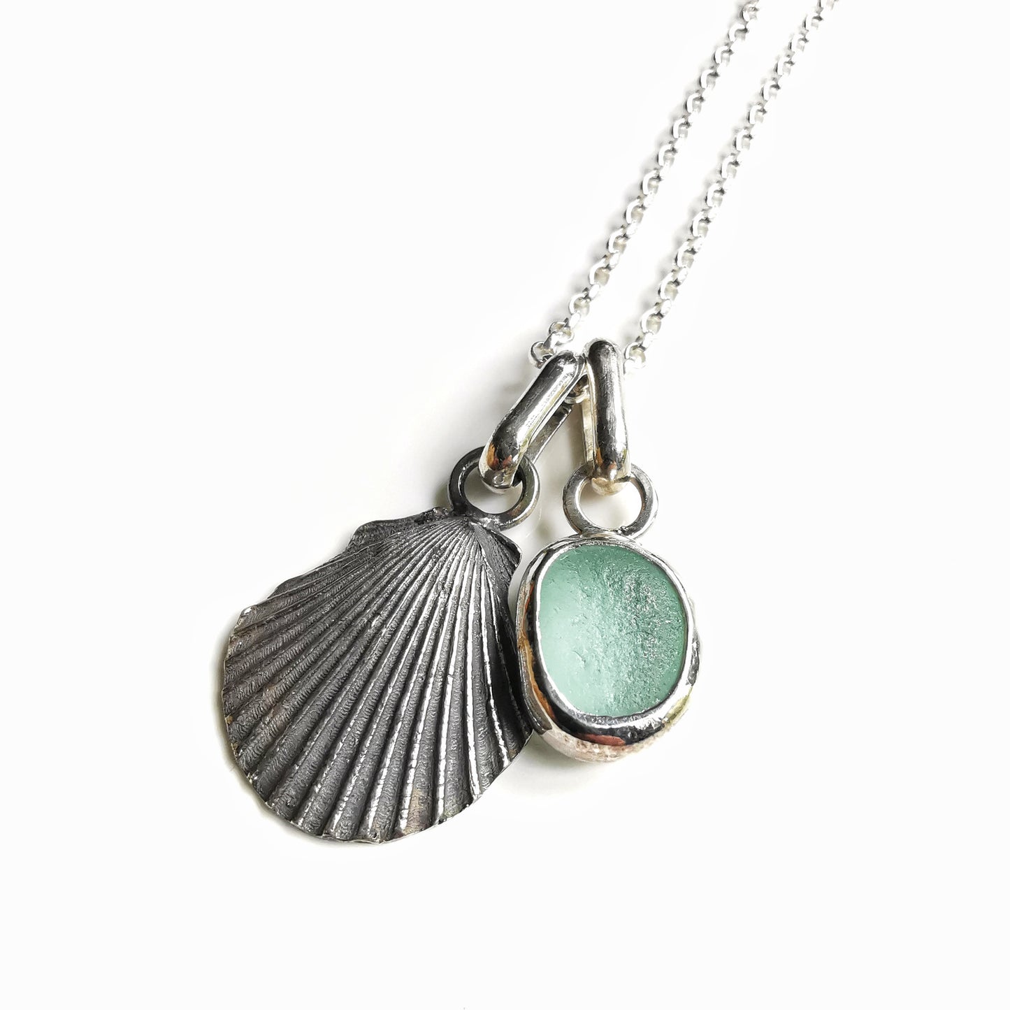 Seafoam sea glass and silver shell pendants duo.