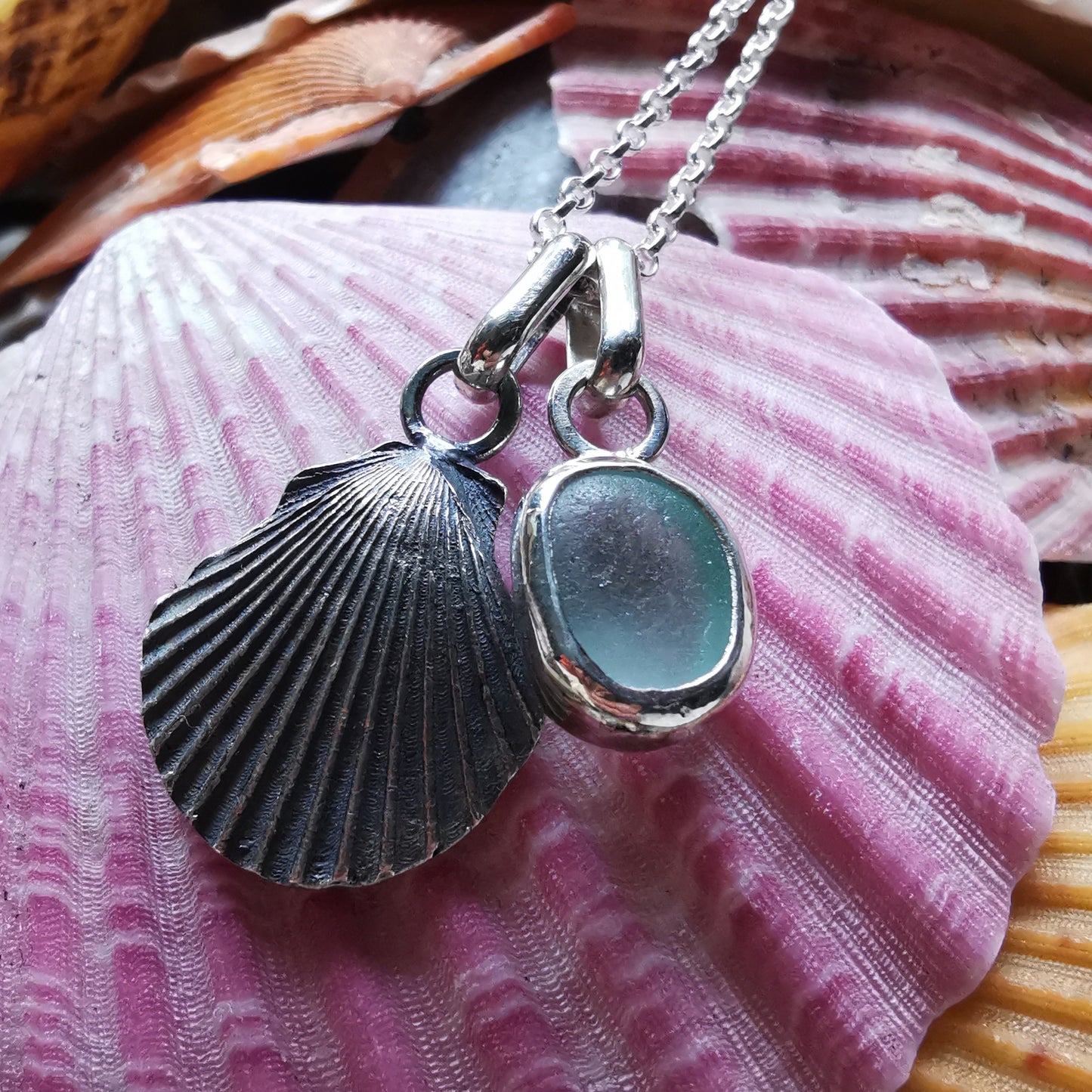 Seafoam sea glass and silver shell pendants duo.