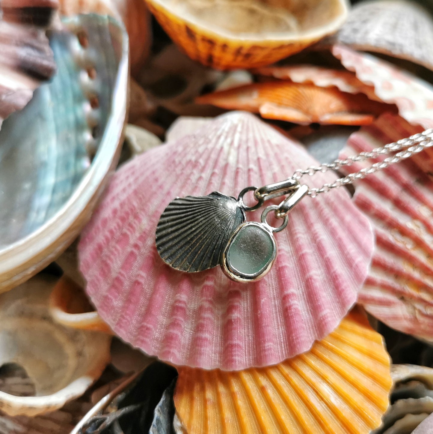 Seafoam sea glass and silver shell pendants duo.