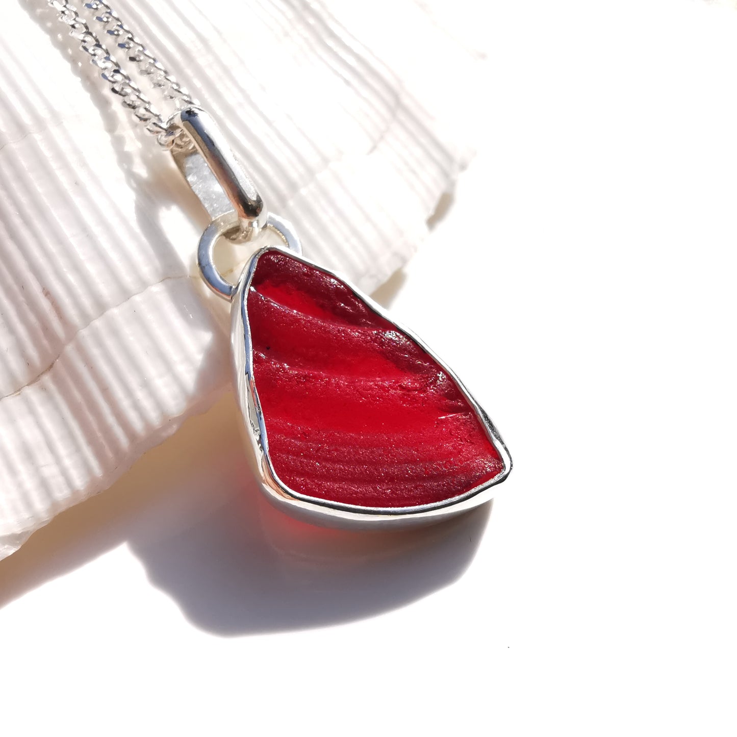 Red amberina UV sea glass & sterling silver pendant