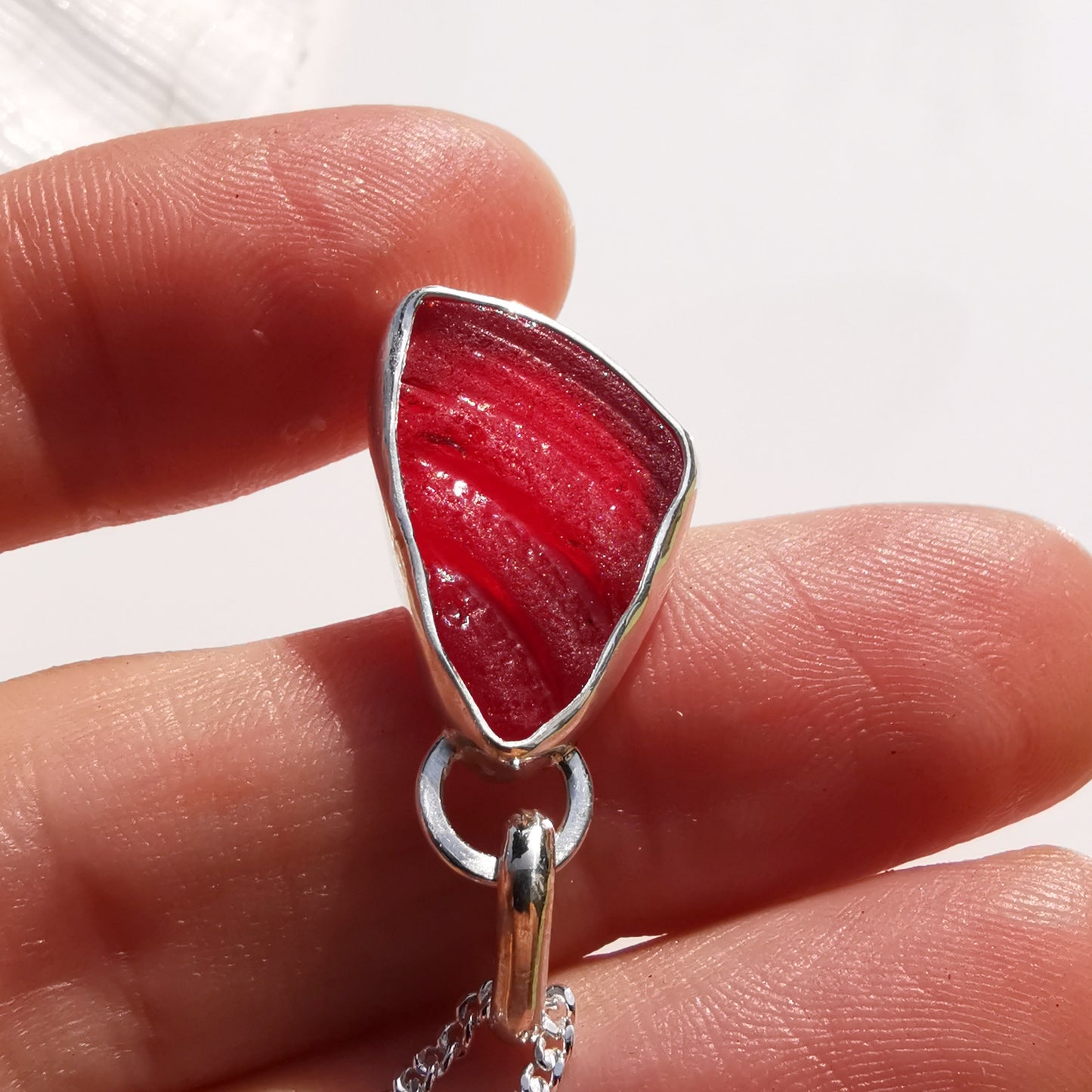 Red amberina UV sea glass & sterling silver pendant