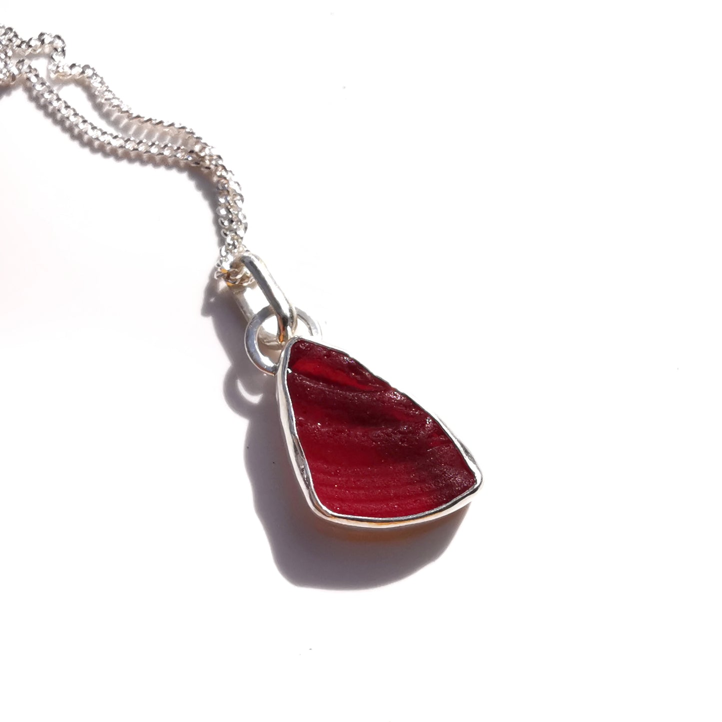 Red amberina UV sea glass & sterling silver pendant