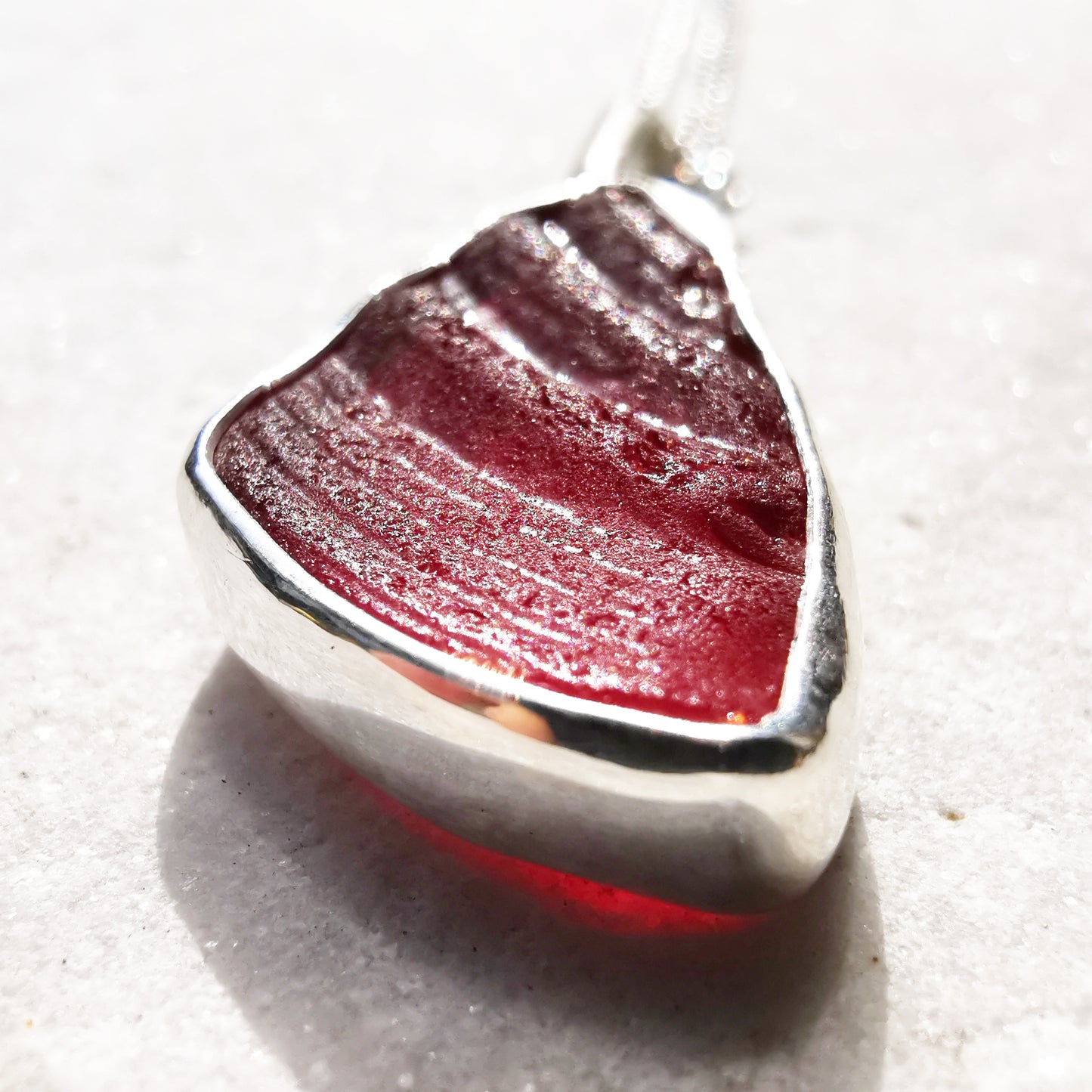 Red amberina UV sea glass & sterling silver pendant