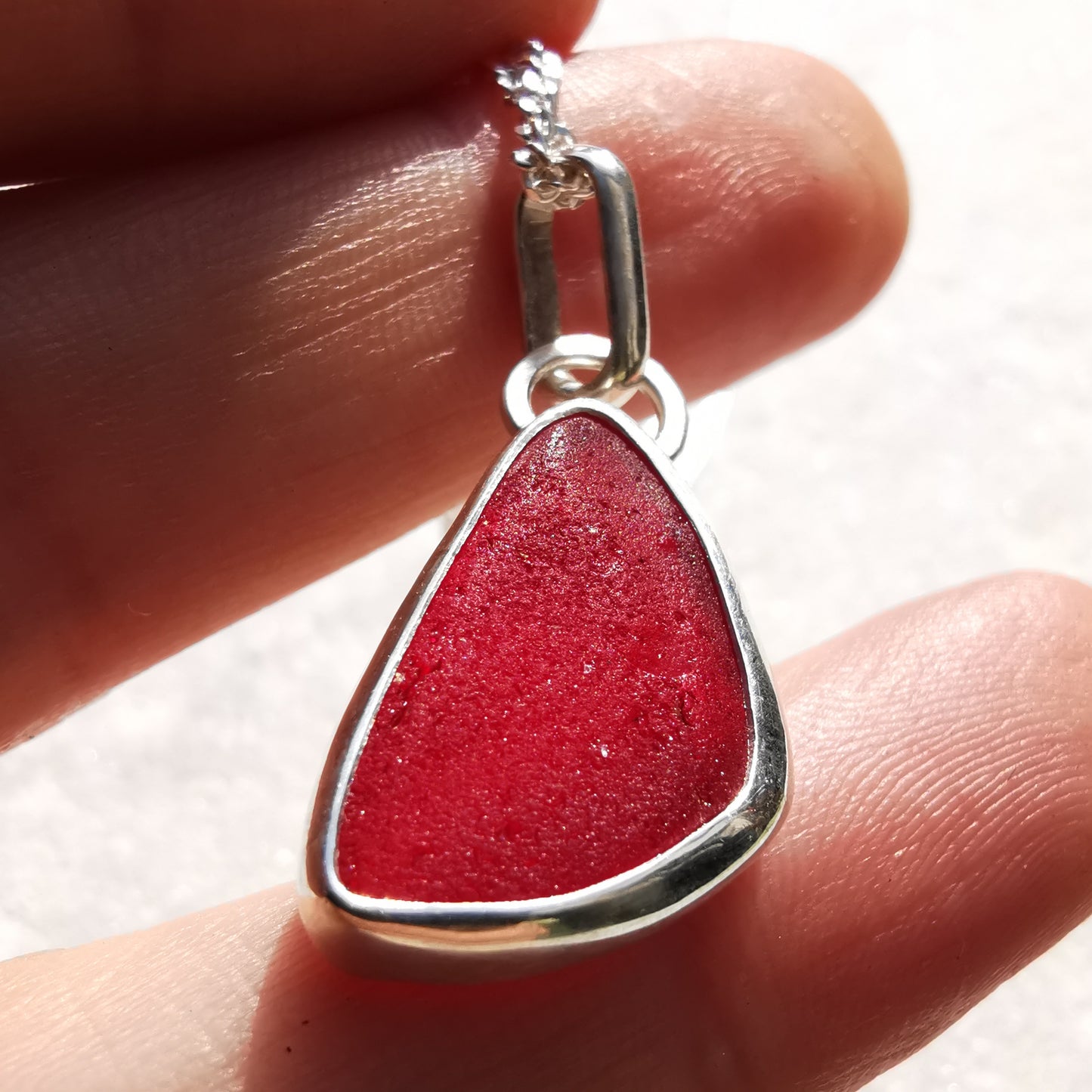 Red amberina UV sea glass & sterling silver pendant