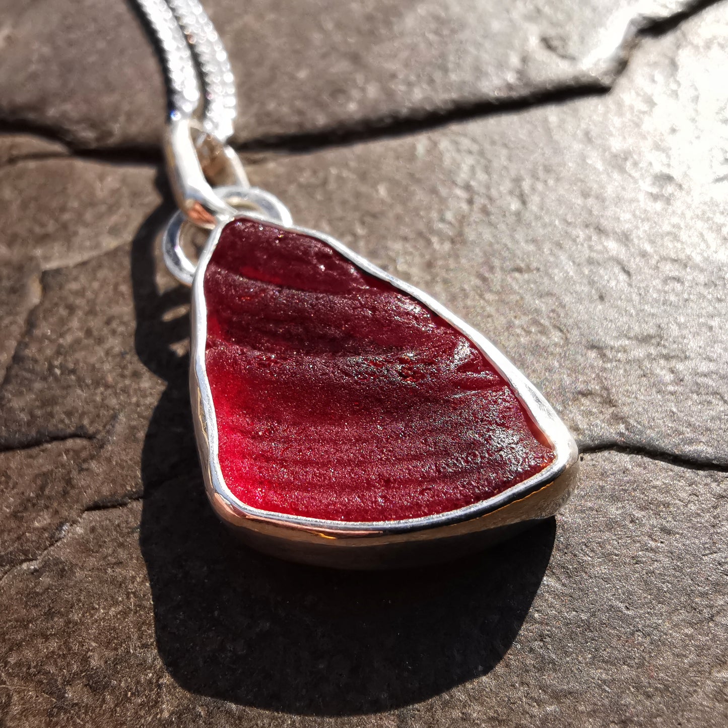 Red amberina UV sea glass & sterling silver pendant