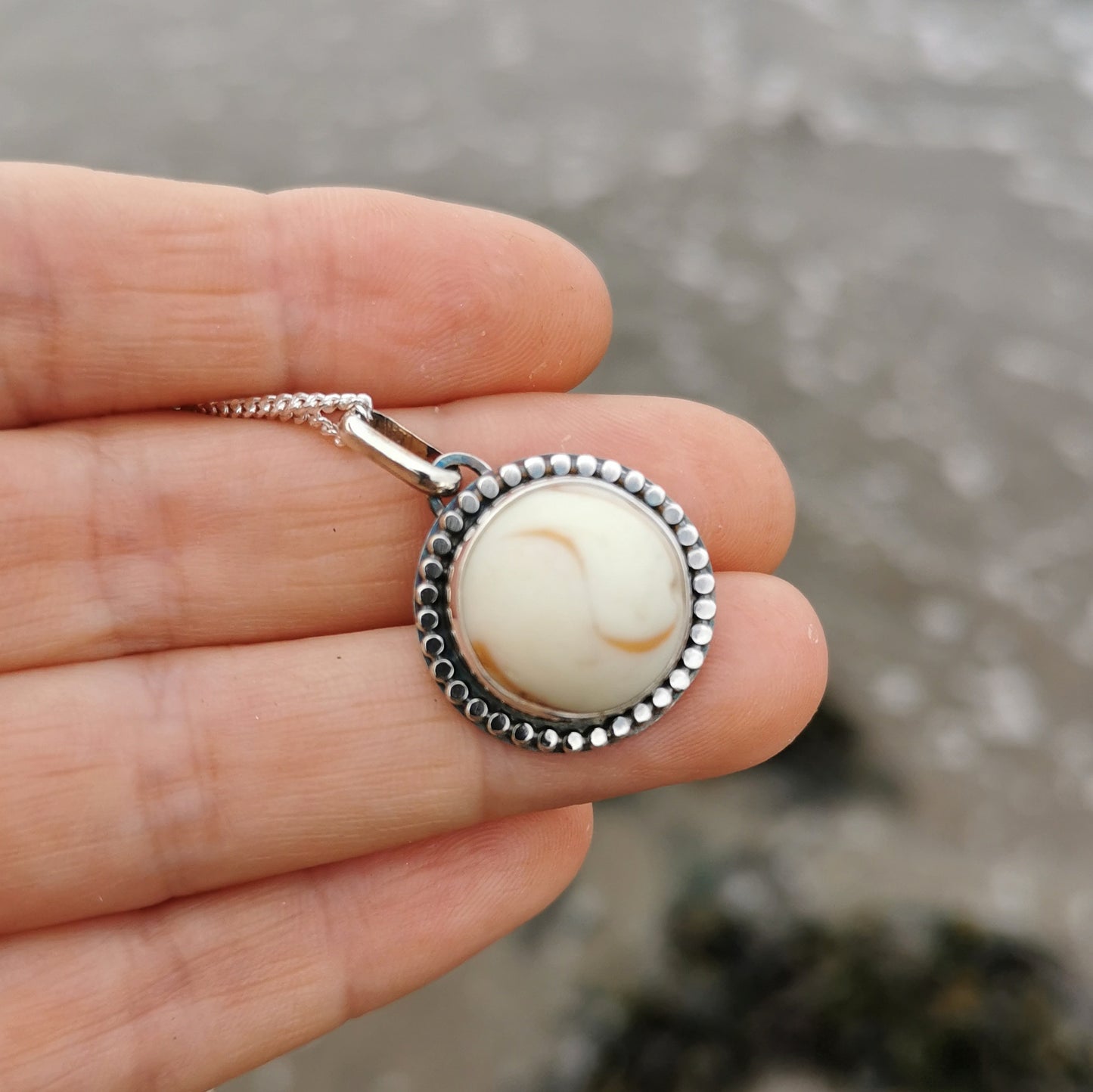 Scottish off white UV partial sea glass marble & sterling silver pendant.