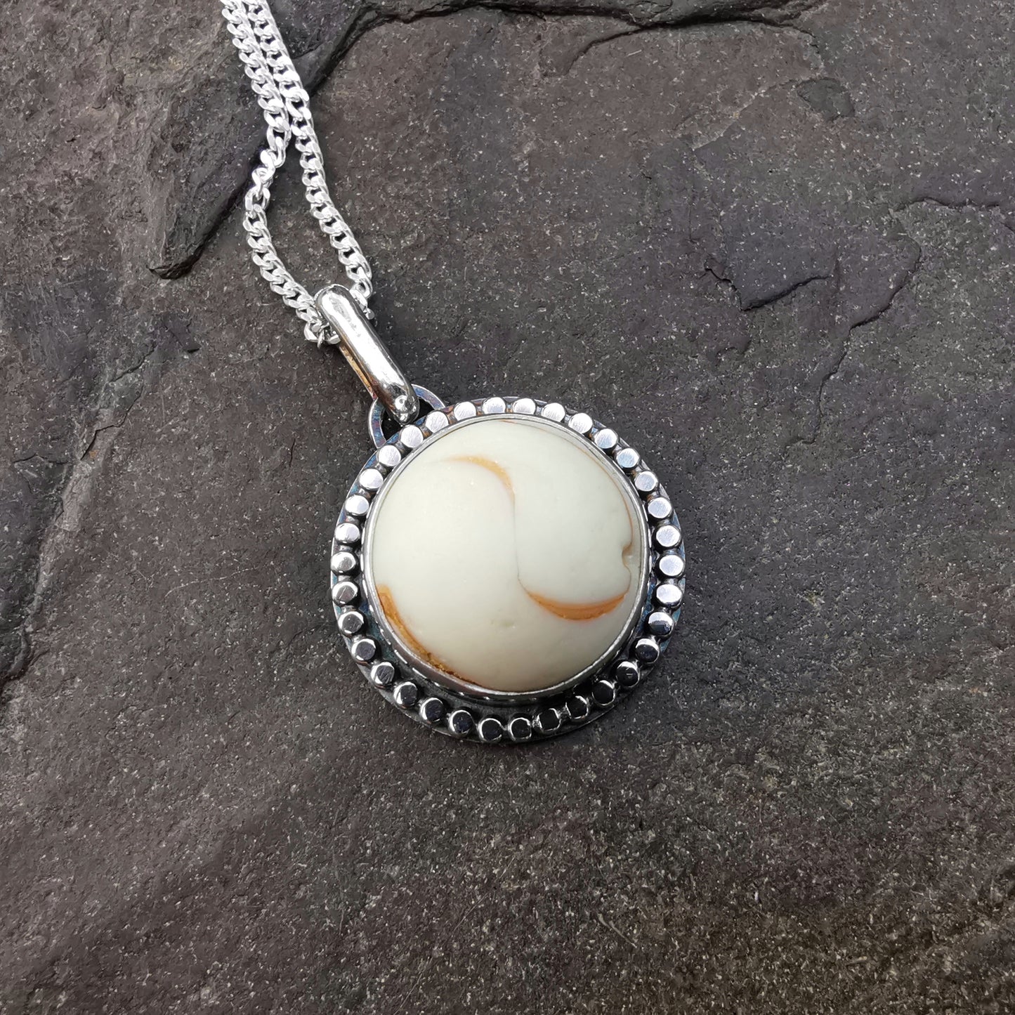 Scottish off white UV partial sea glass marble & sterling silver pendant.