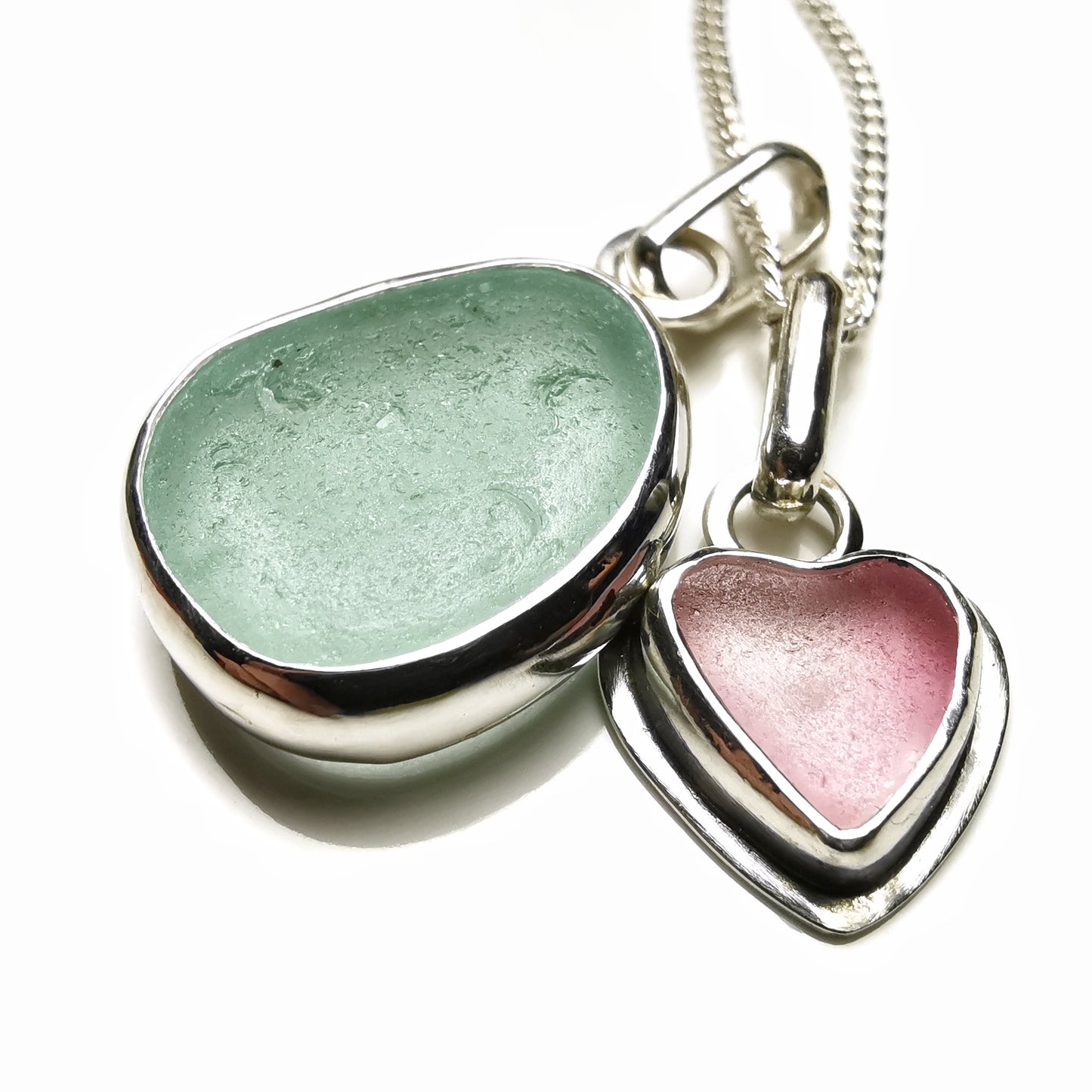 Tiny Scottish pink sea glass heart and light teal blue duo pendants in sterling silver.