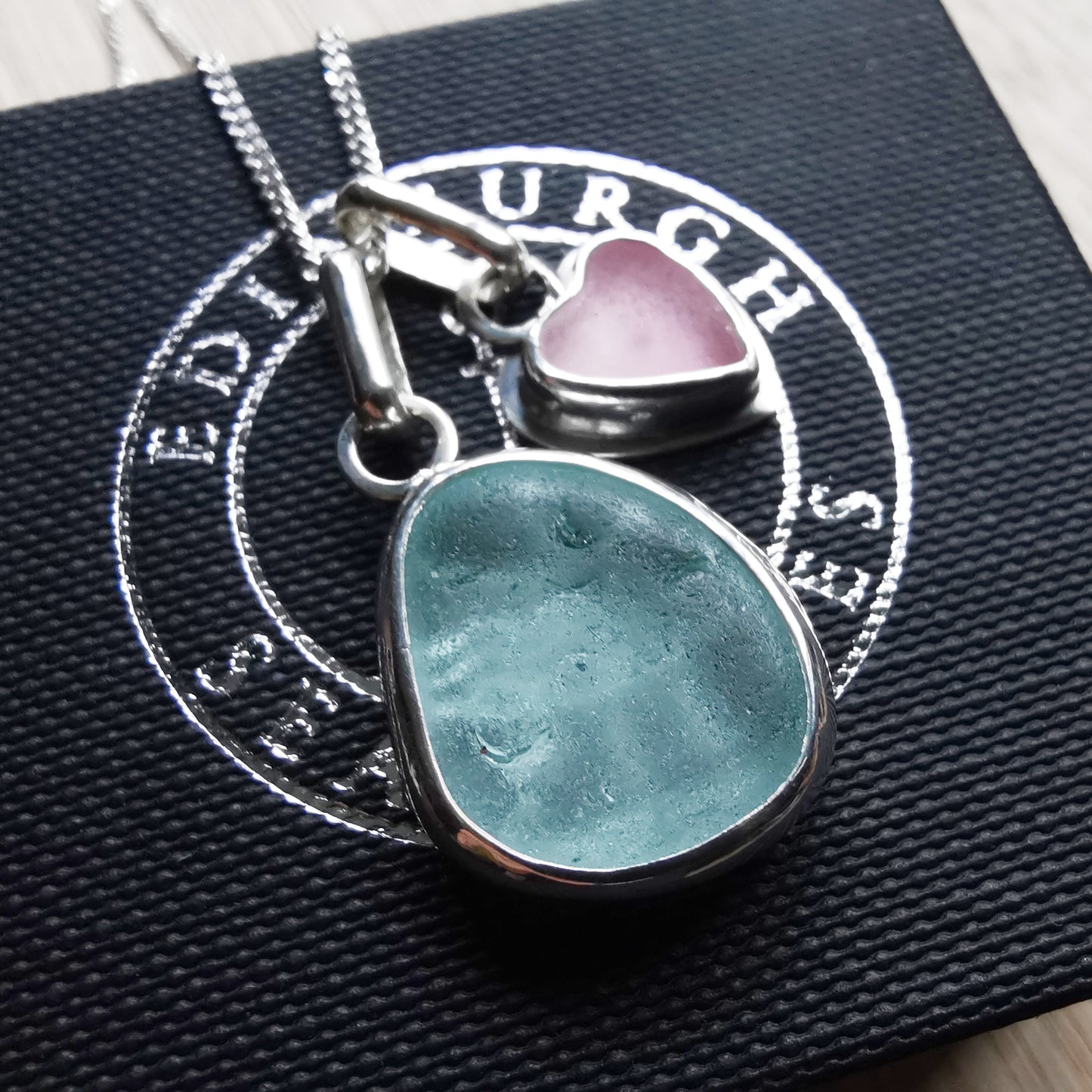 Tiny Scottish pink sea glass heart and light teal blue duo pendants in sterling silver.