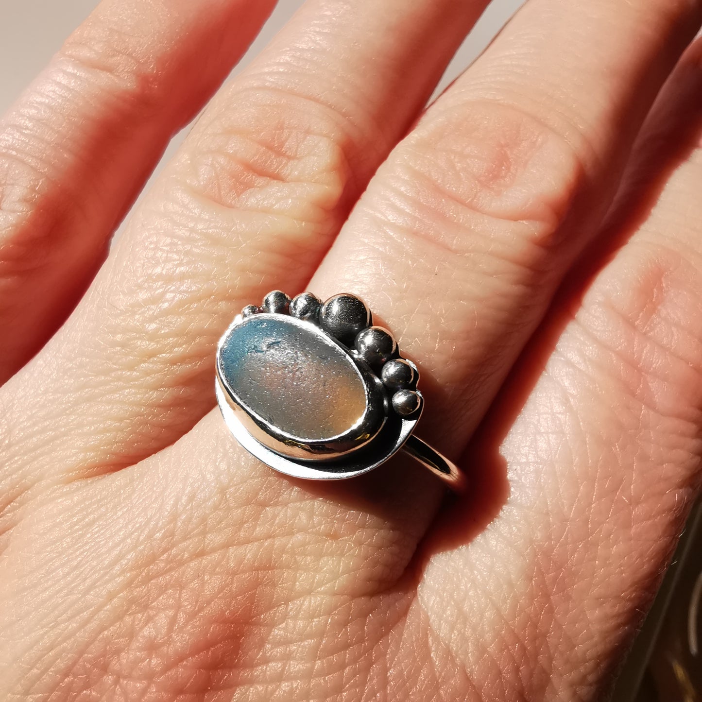 Opalescent sea glass & sterling silver adjustable ring.