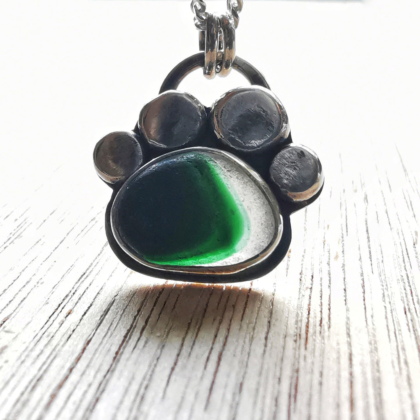 Seaham green and clear multi sea glass & sterling silver paw pendant.