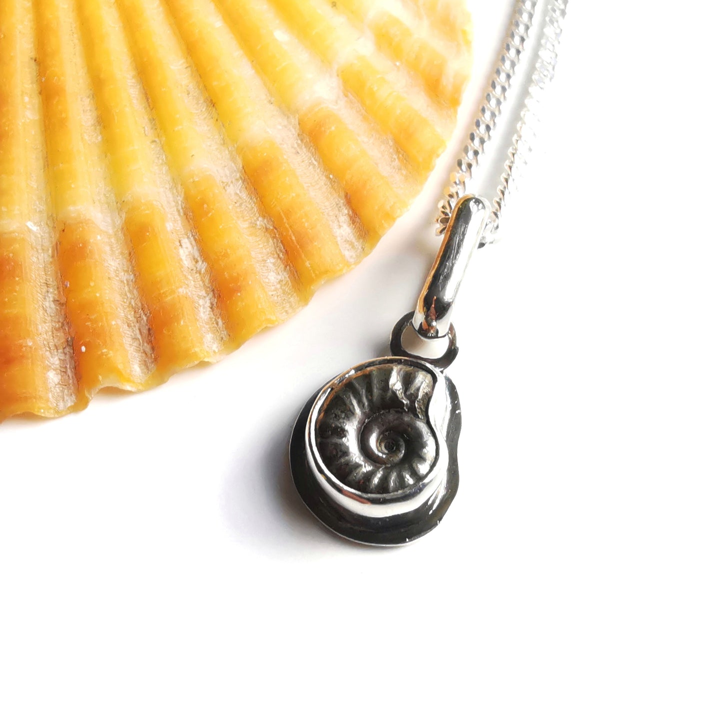 Tiny ammonite fossil & sterling silver pendant.