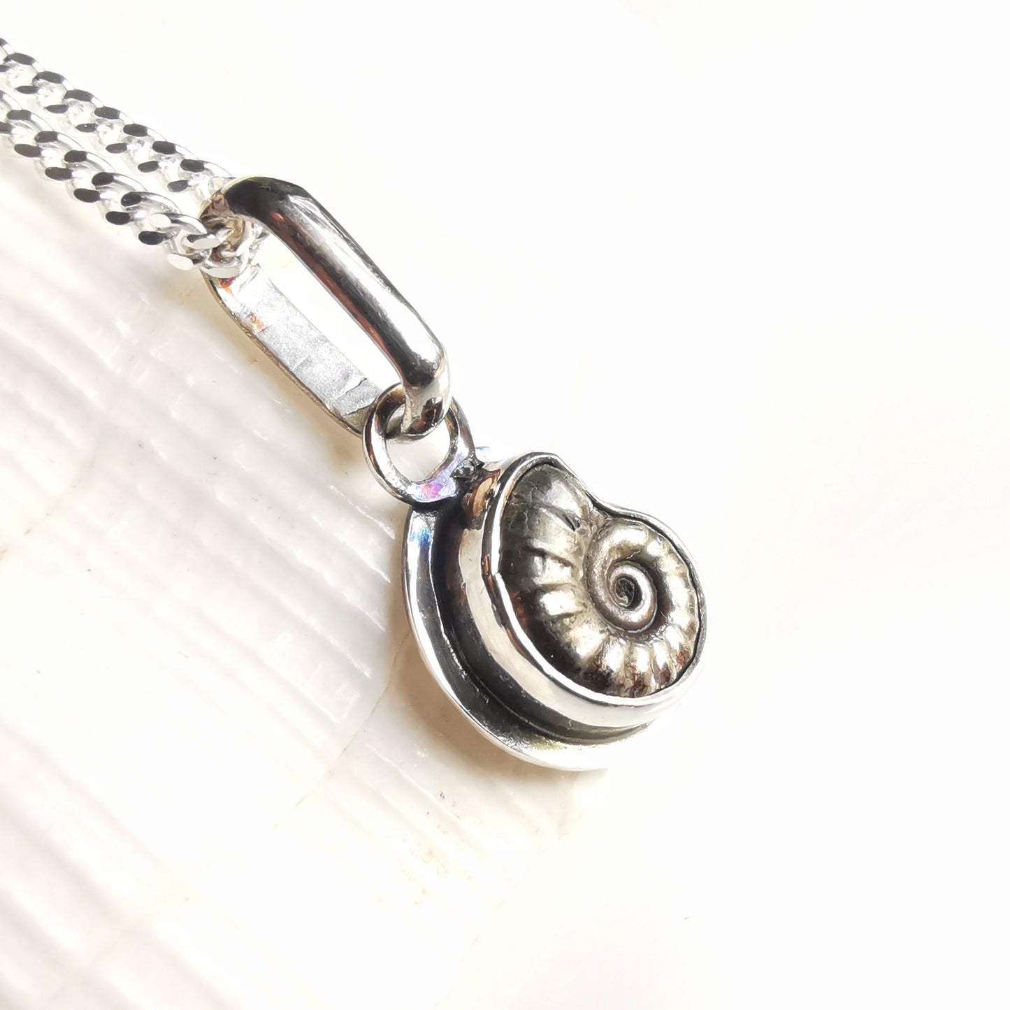 Tiny ammonite fossil & sterling silver pendant.