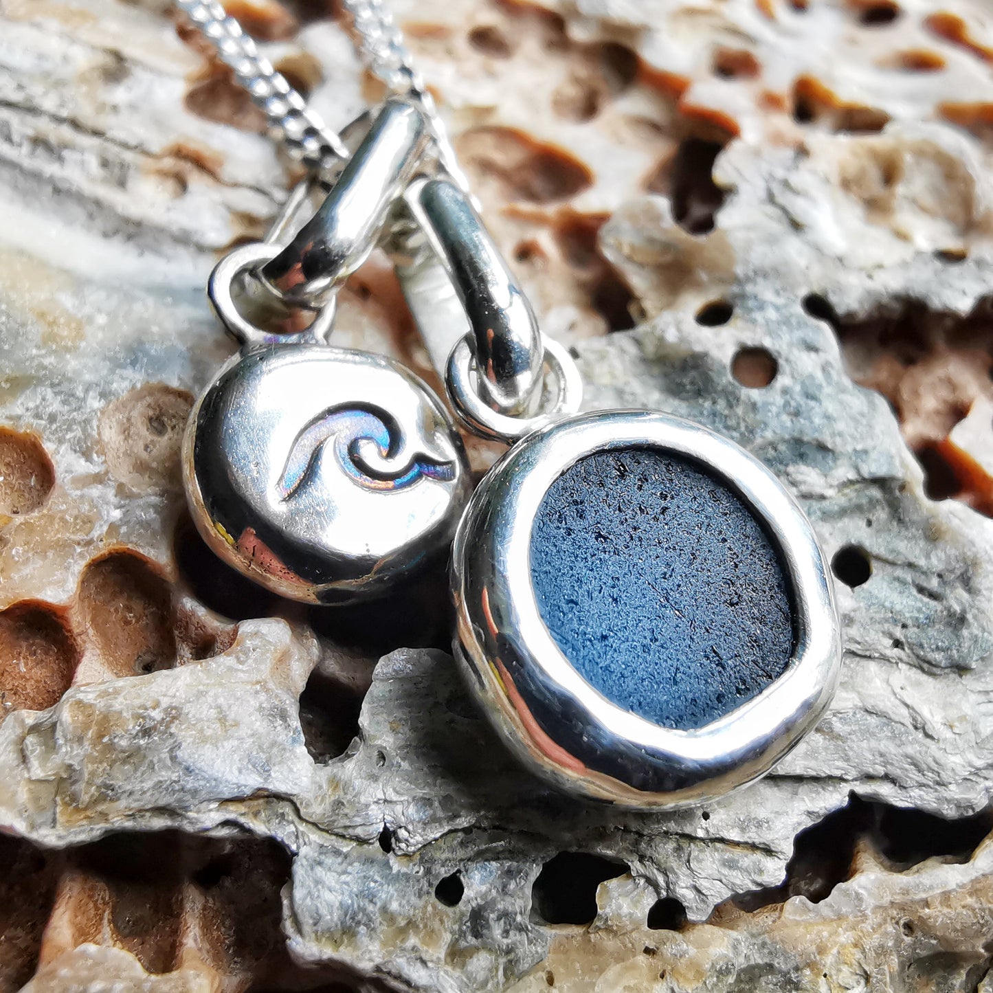 Tiny Scottish teal blue sea glass and wave pebble duo of sterling silver pendants.