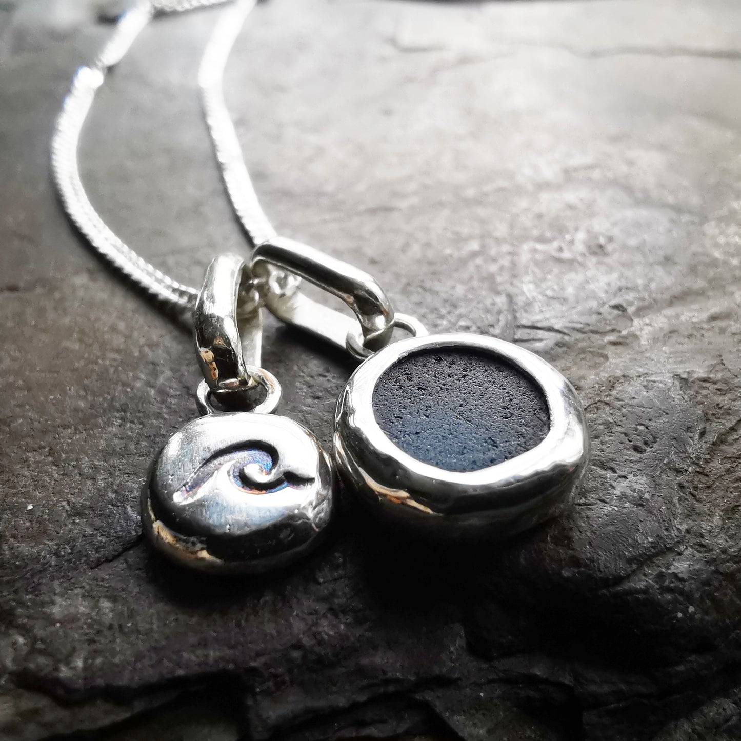 Tiny Scottish teal blue sea glass and wave pebble duo of sterling silver pendants.