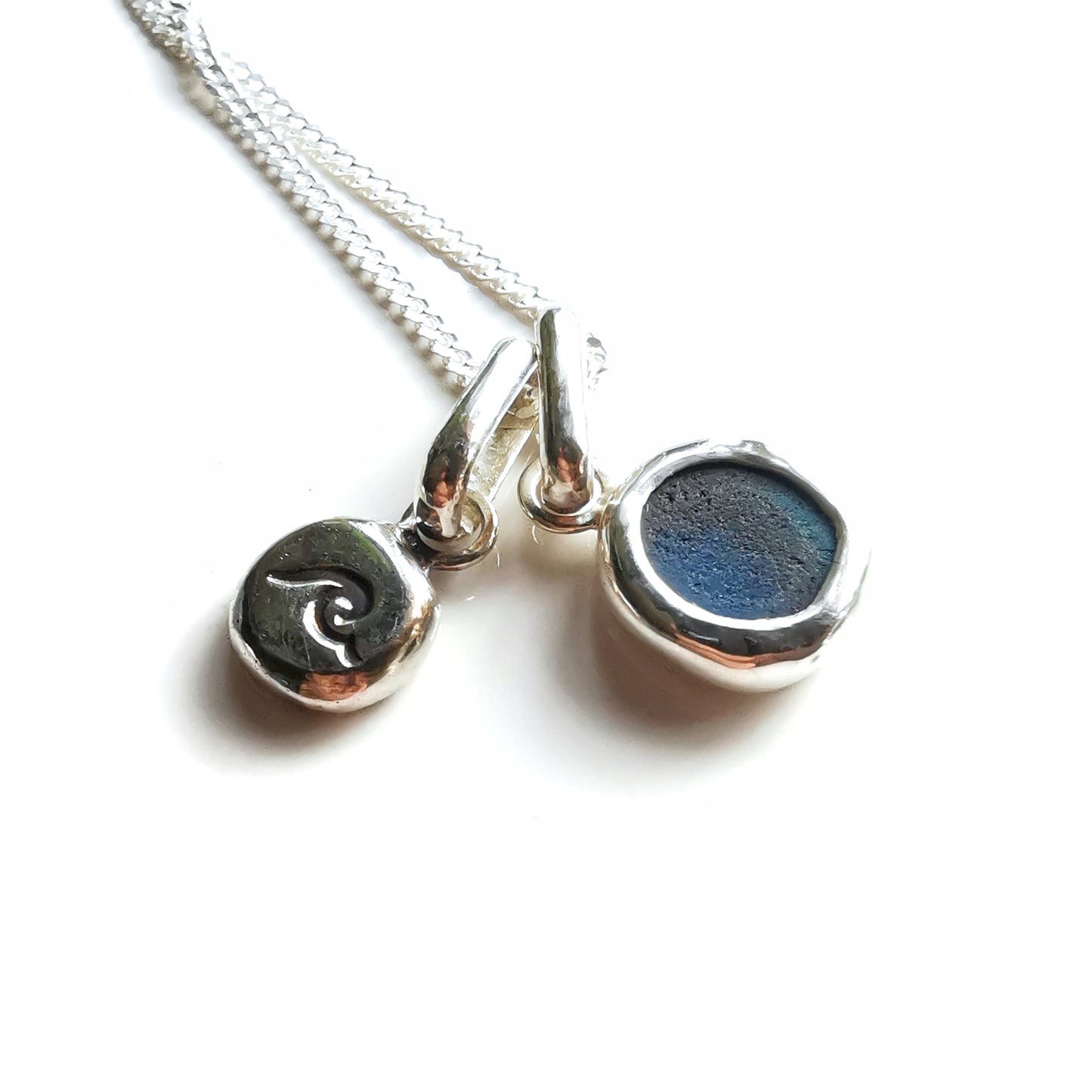 Tiny Scottish teal blue sea glass and wave pebble duo of sterling silver pendants.