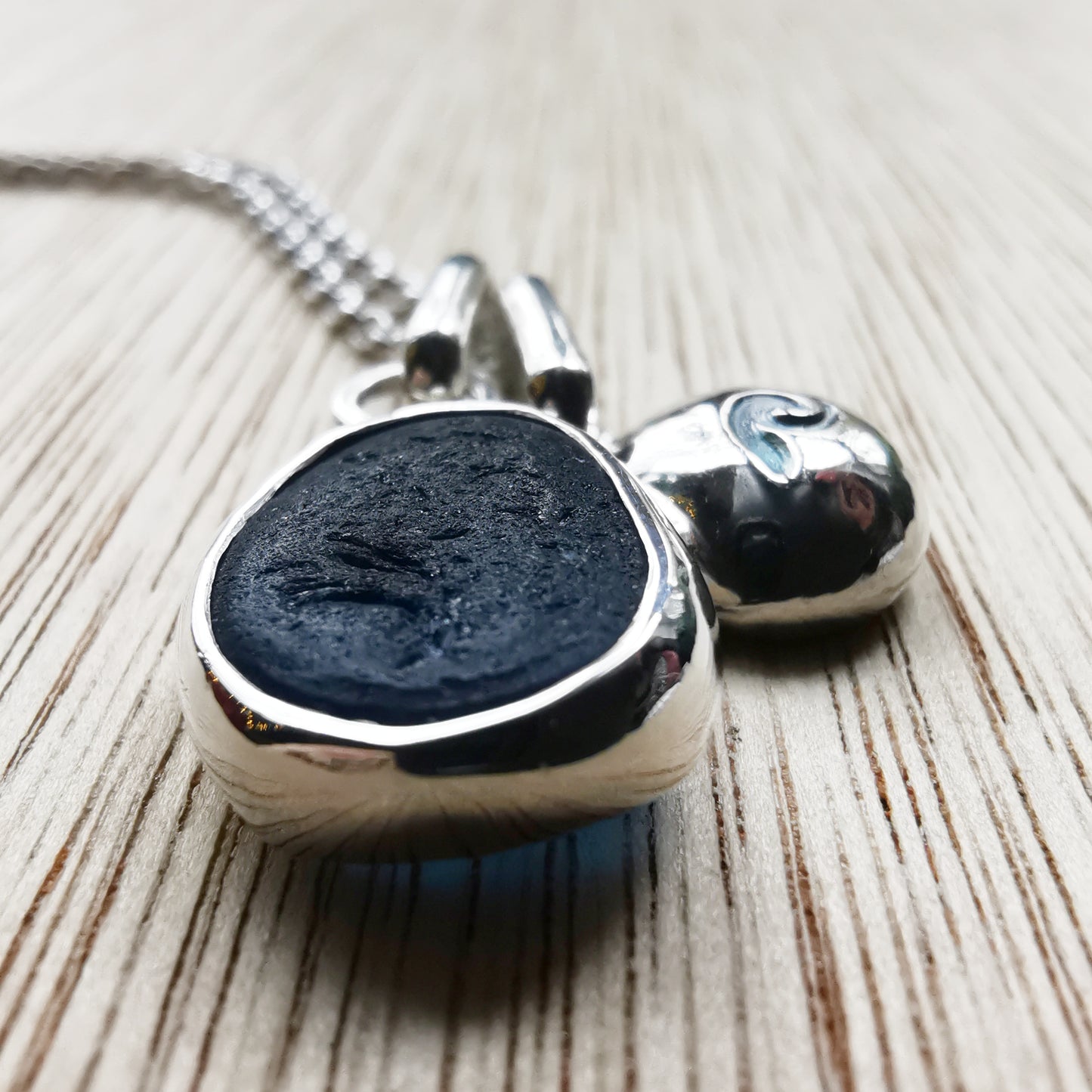 Seaham blue sea glass and silver wave pebble duo of pendants.