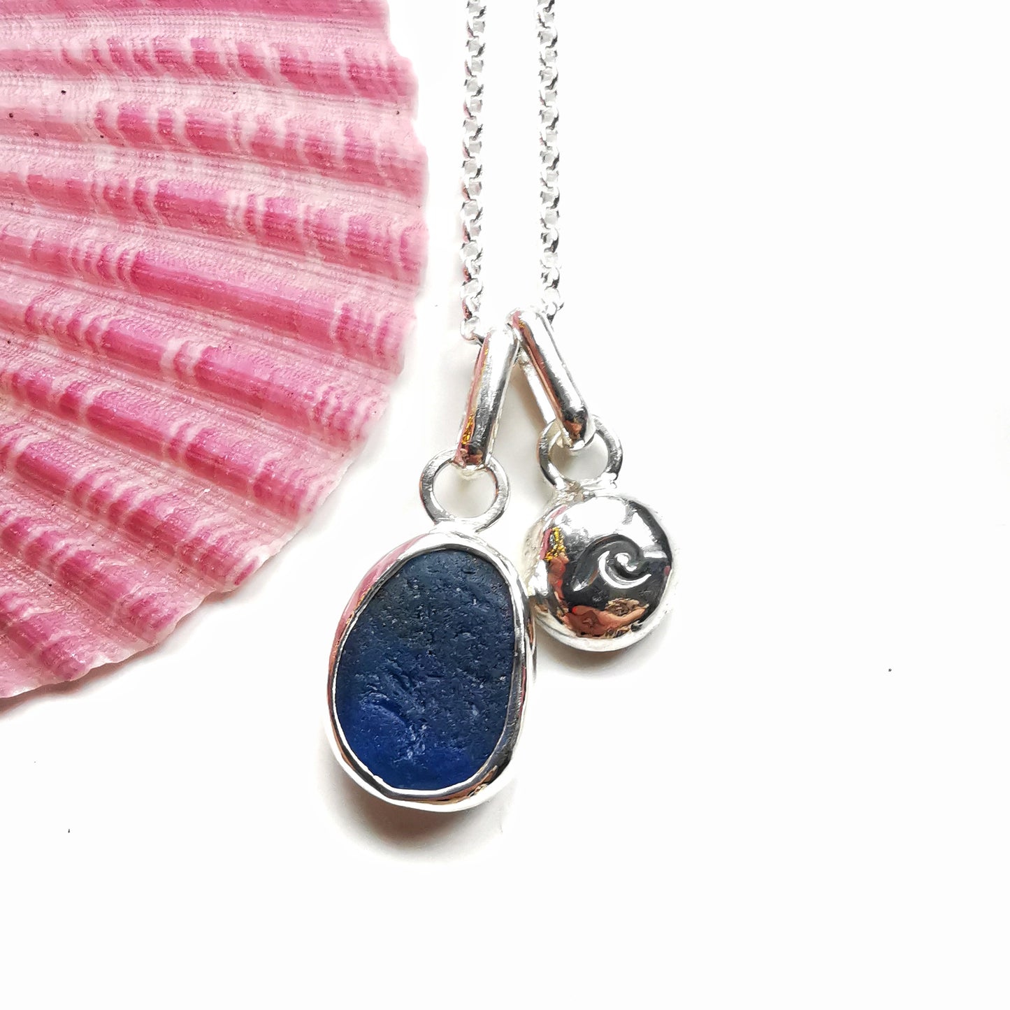 Seaham blue sea glass and silver wave pebble duo of pendants.