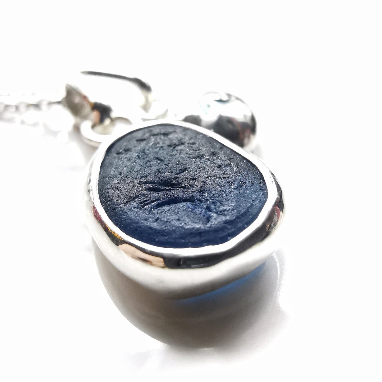 Seaham blue sea glass and silver wave pebble duo of pendants.