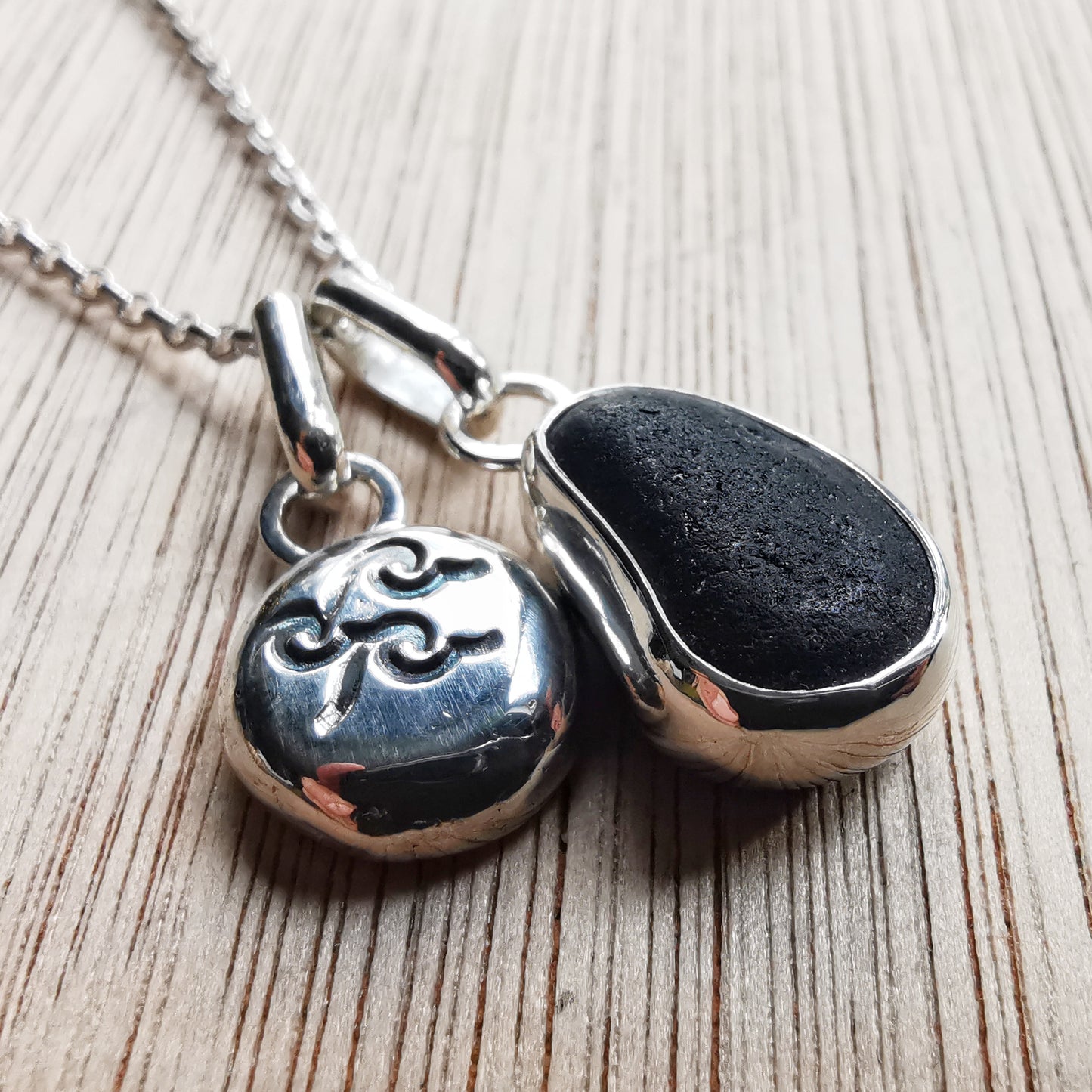 Black/purple Seaham sea glass pendant and sterling silver wave pebble duo.