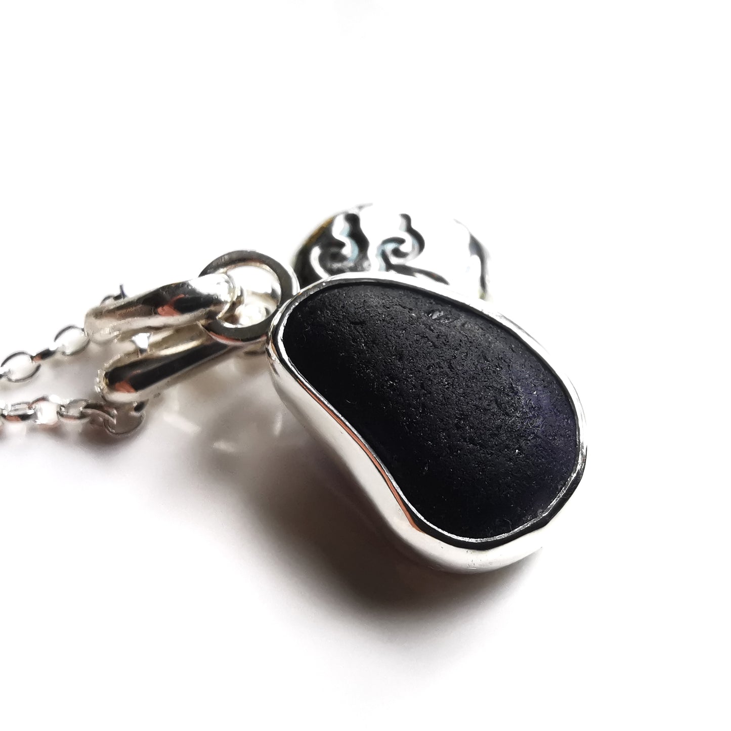 Black/purple Seaham sea glass pendant and sterling silver wave pebble duo.